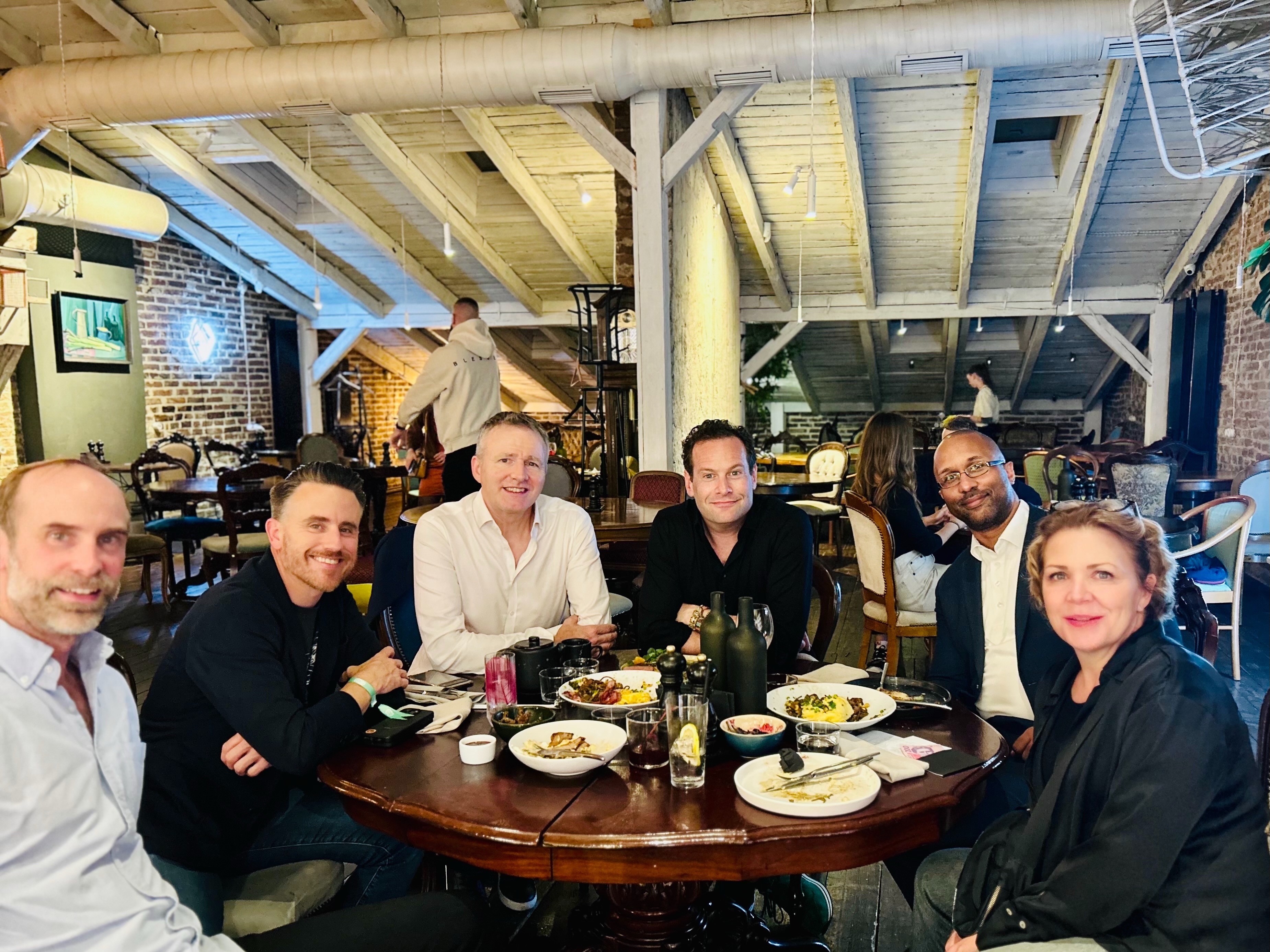 Green Flag team members having dinner in Lviv, Ukraine, during the IT Arena event, 2025.