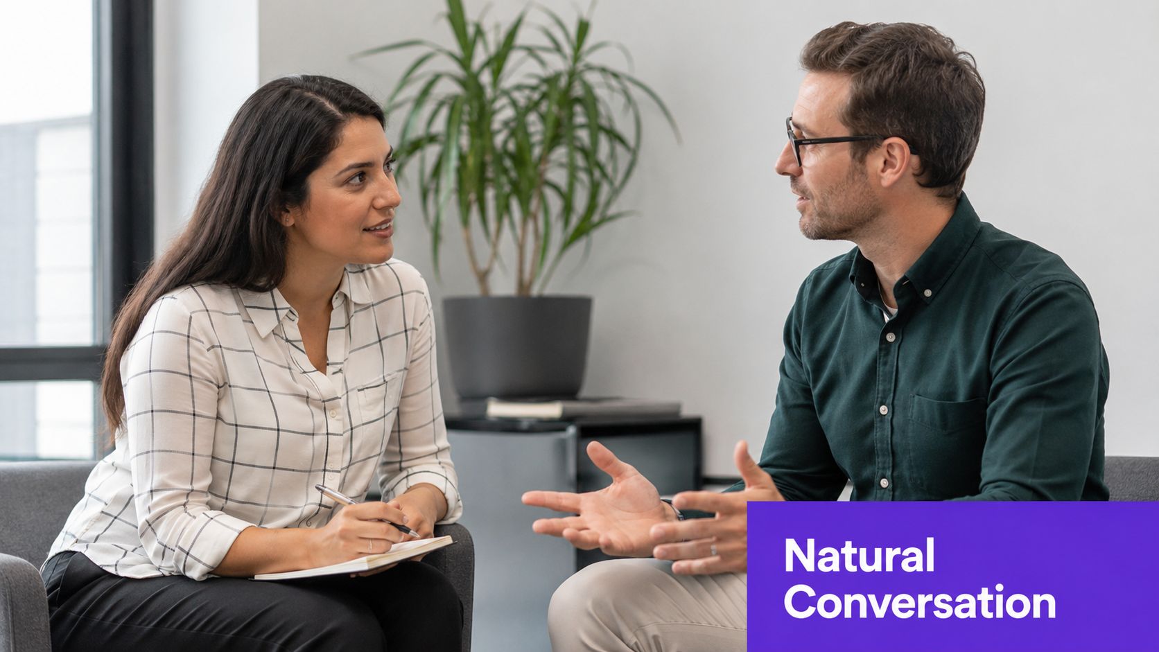 A woman and a man having a professional meeting while sitting in a bright office space.