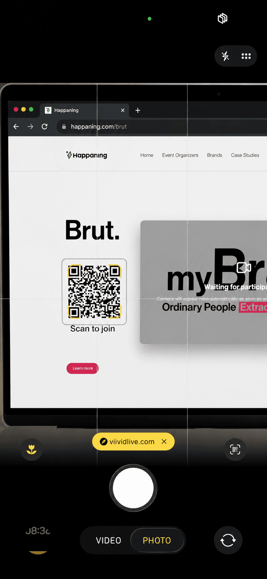 iOS camera scanning the QR code on a laptop screen