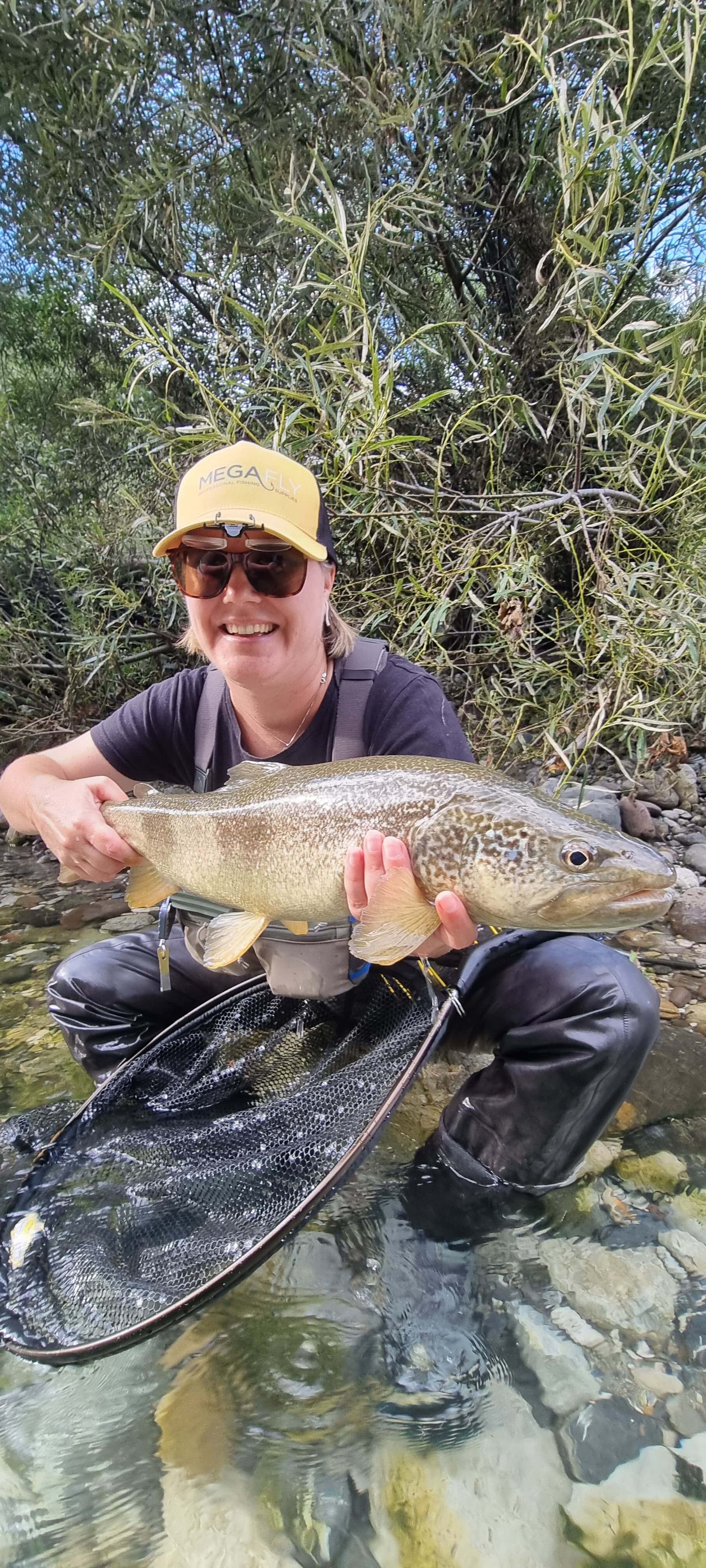 Fly fishing Slovenia on the turquoise Soča River surrounded by alpine mountains and clear limestone waters