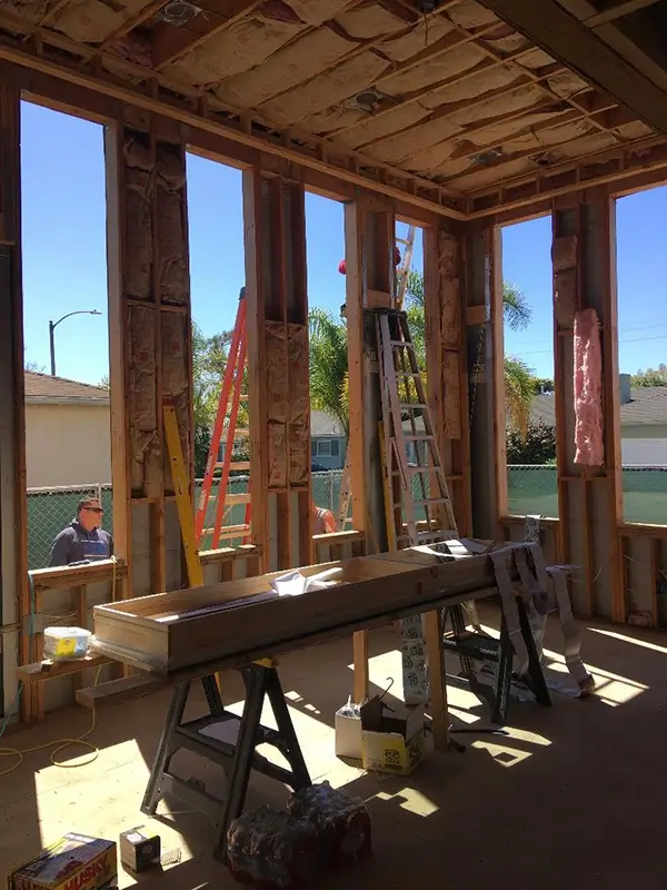 A cell phone sitting on top of a wooden table next to a keyboard