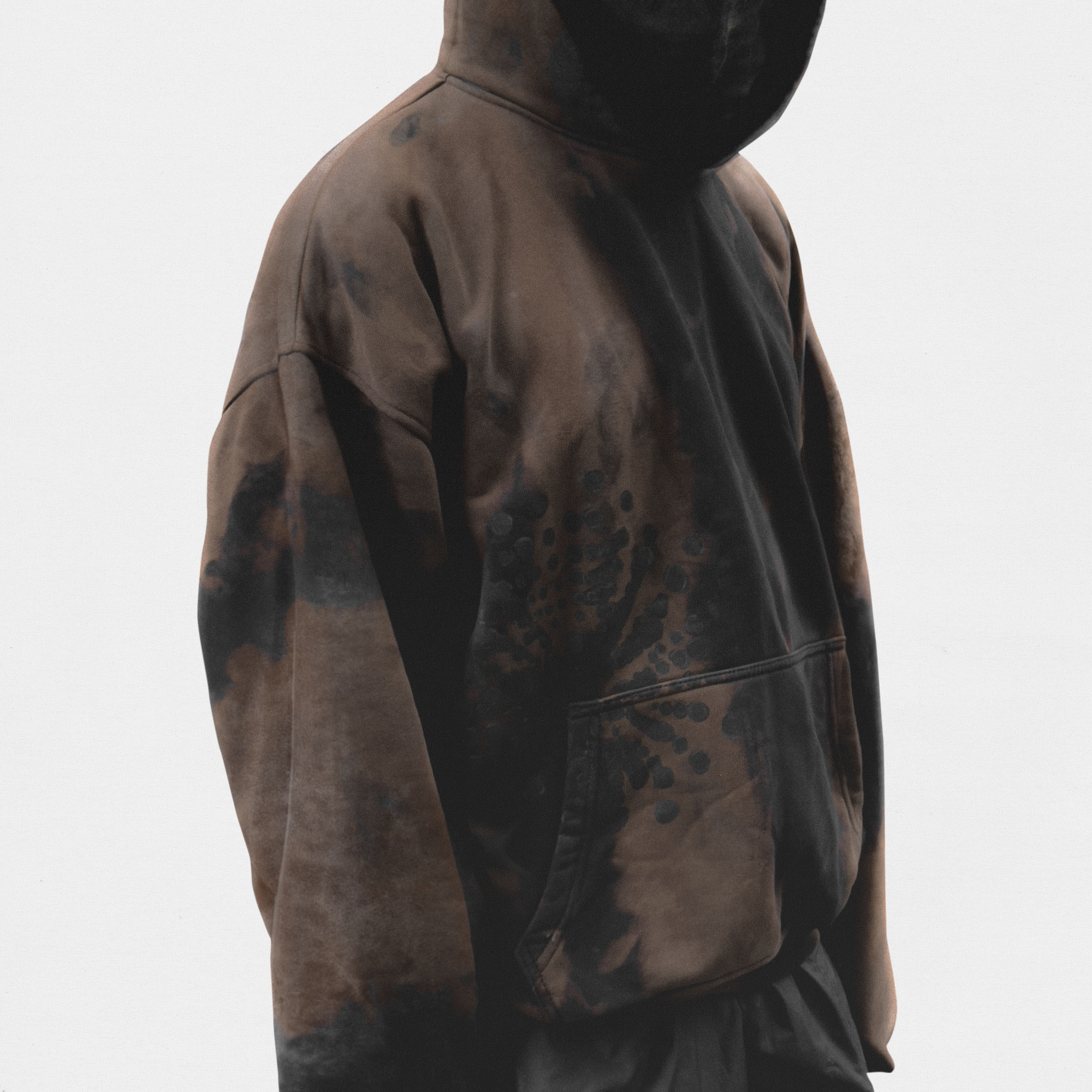 Model wearing brown hoodie on white background