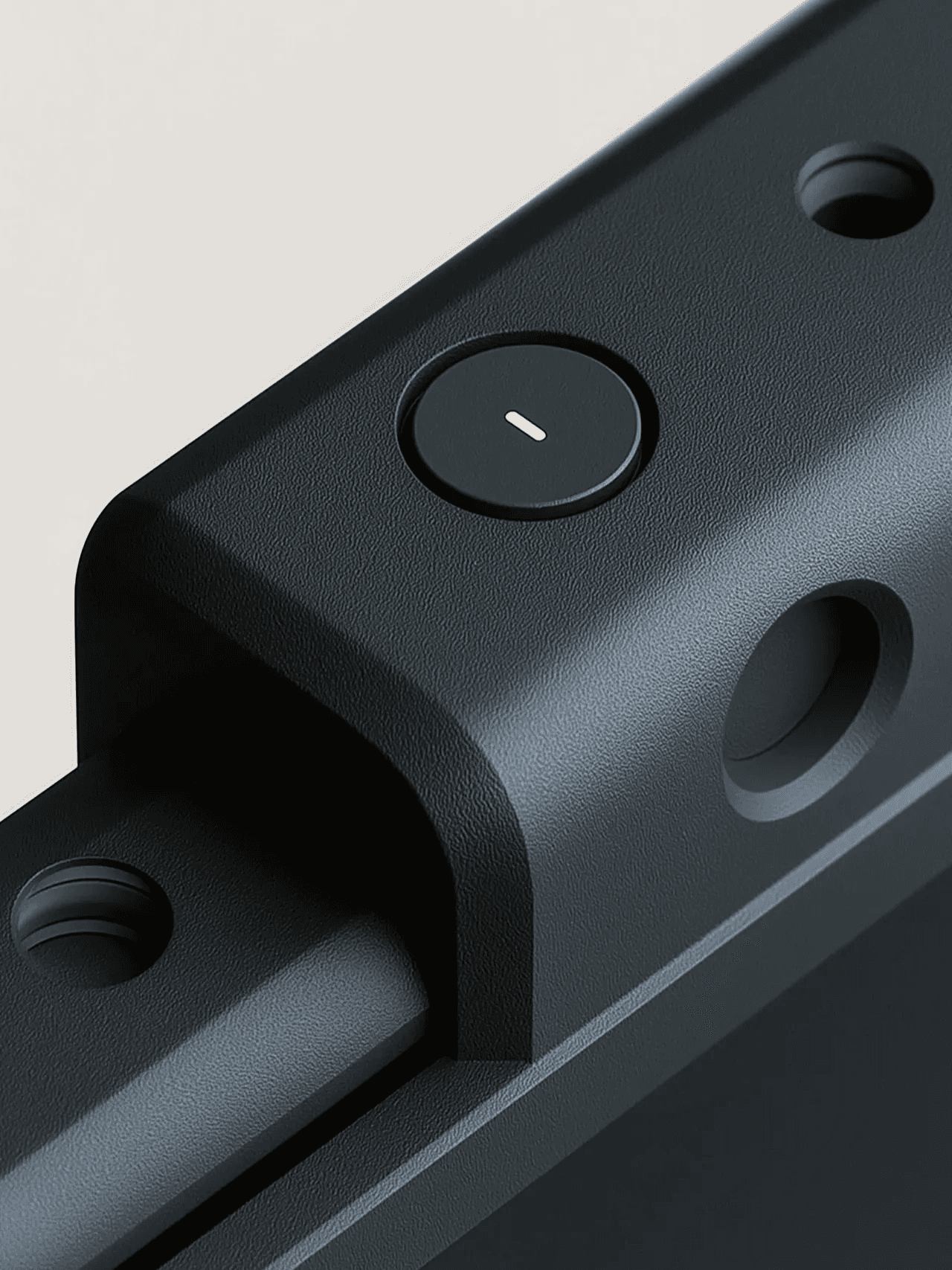 Close up of black industrial housing with round button and recessed openings