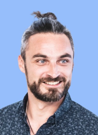 Close-up of a tree stump showing growth rings and a textured brown wood surface.