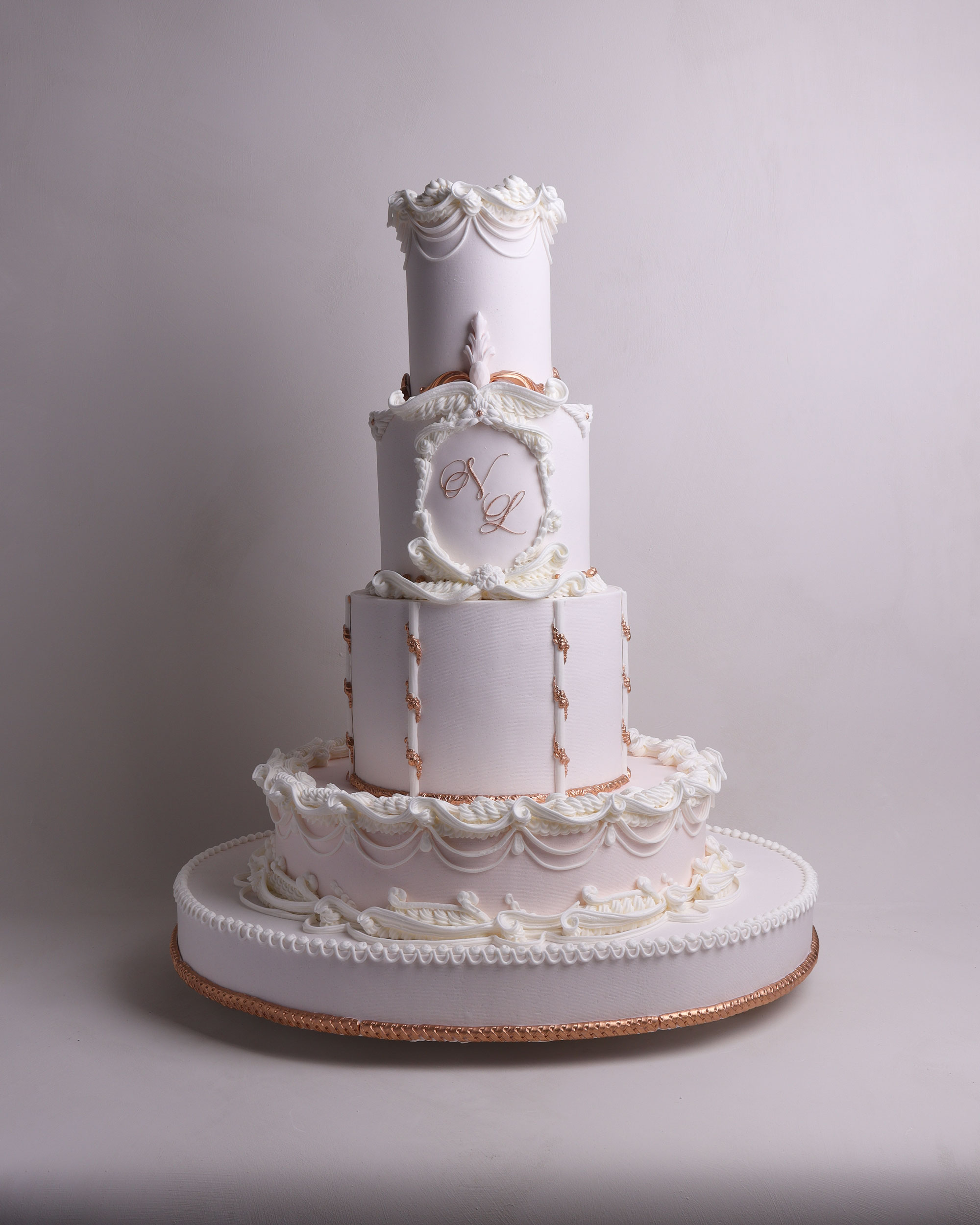 3 tier white wedding cake with fondant draping