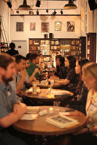 man in black and red shirt reading book