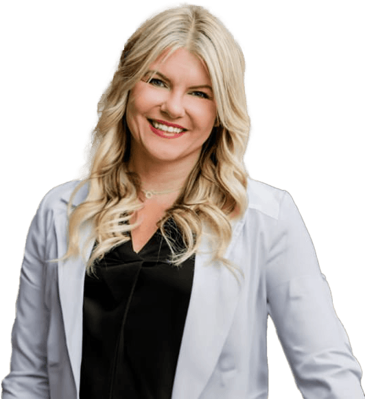 A smiling person with long blonde hair wearing a black top and white blazer, posing against a neutral background.