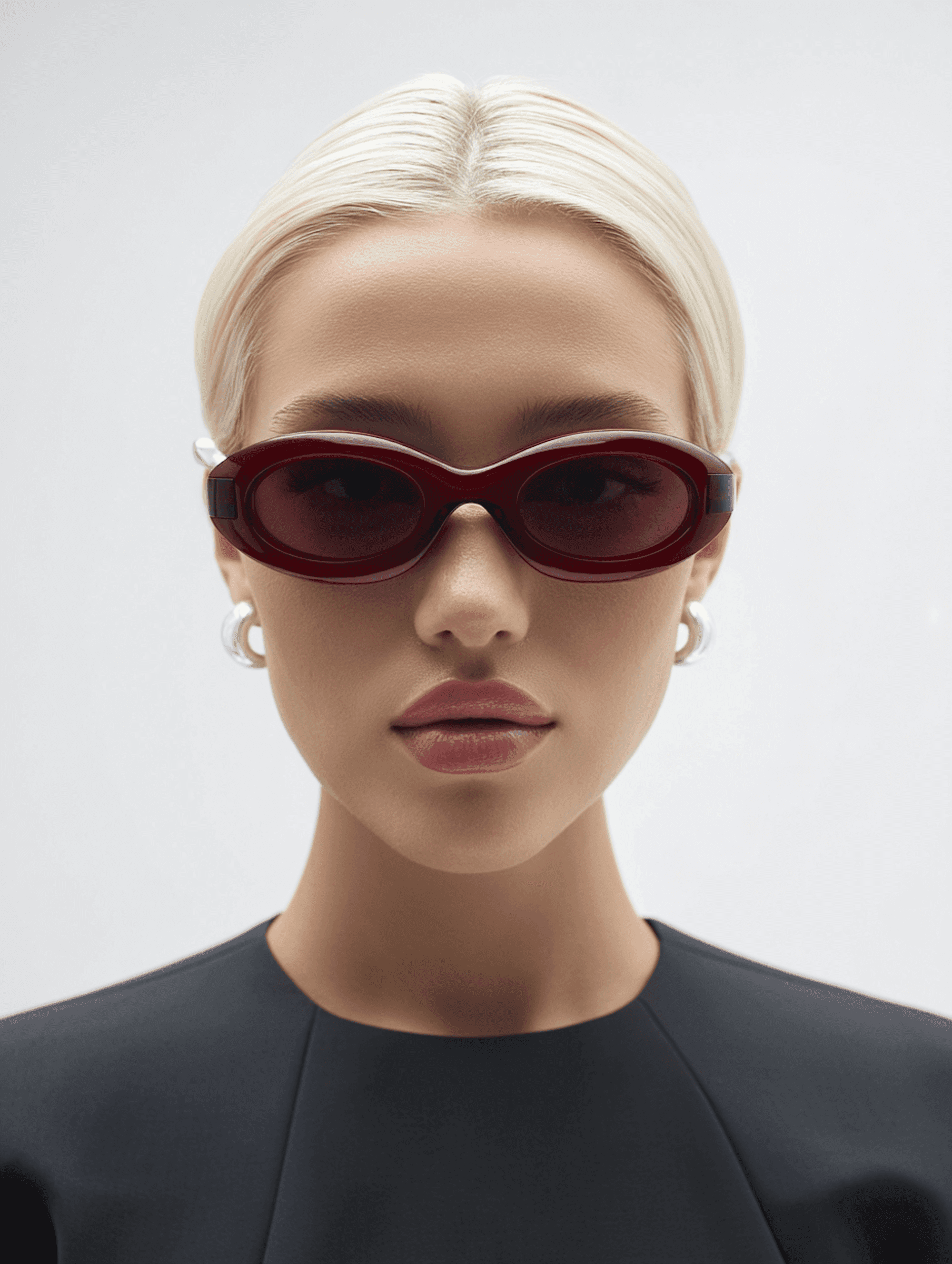 Studio portrait wearing red oval sunglasses