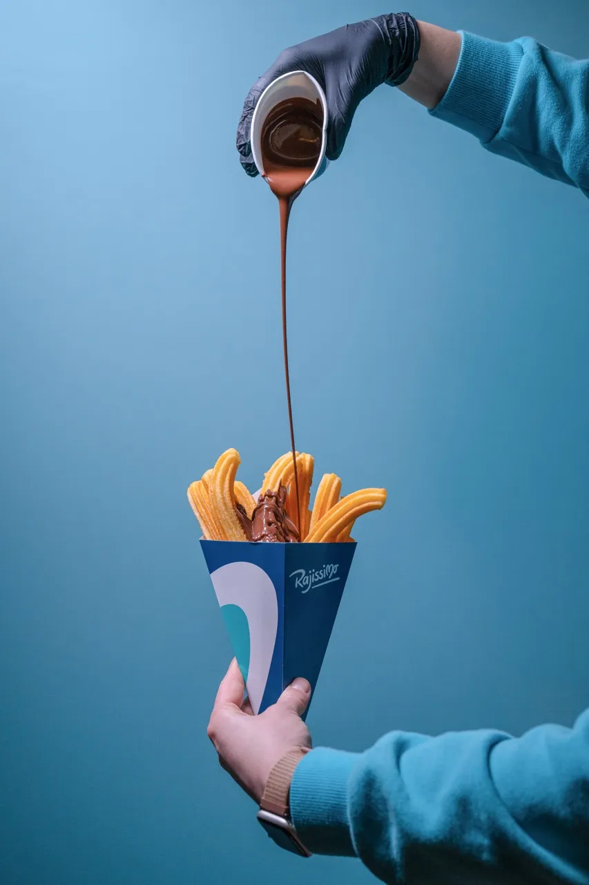 People sharing a portion of churros