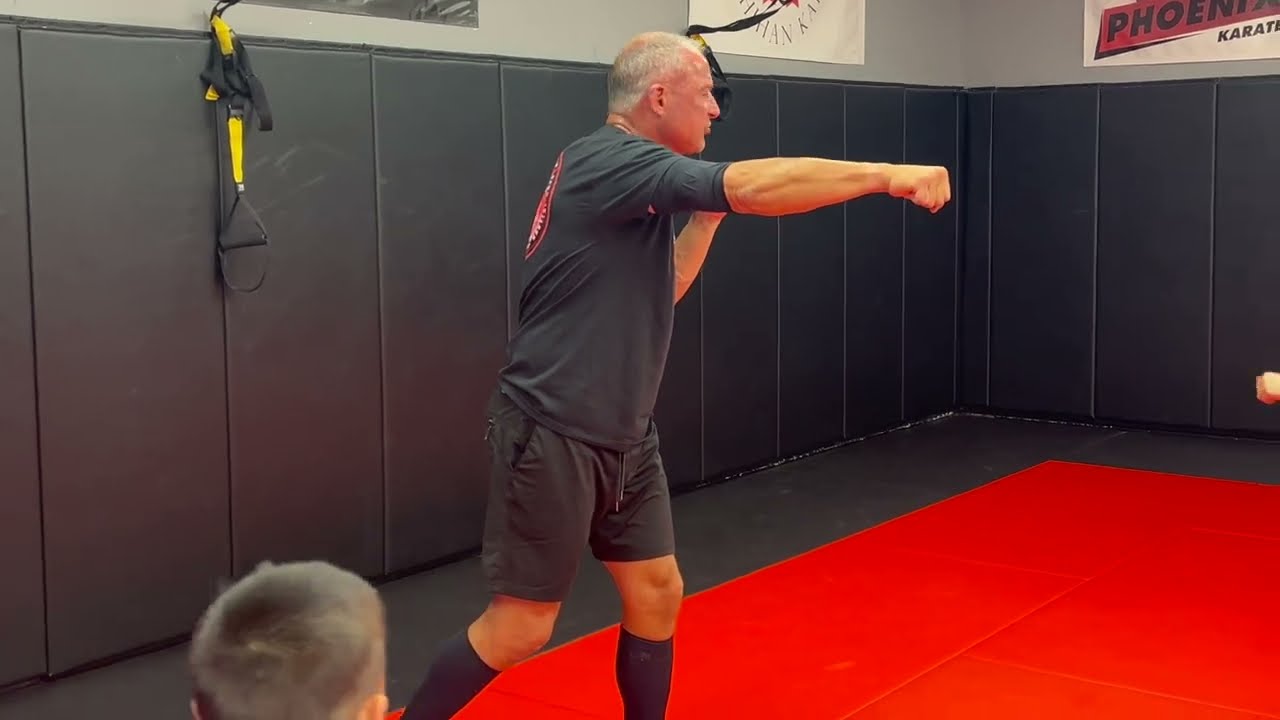 Shihan Anthony Codispoti demonstrating a punch for young students.