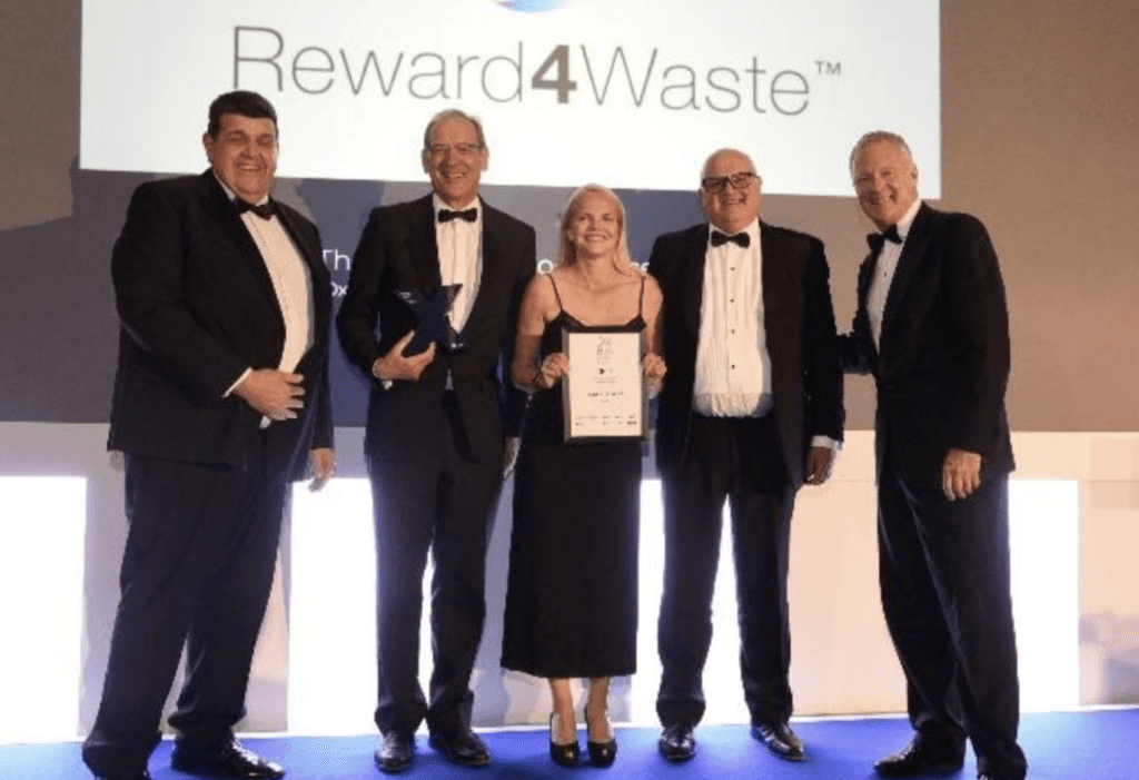 Receiving the Excellence in Technology Award: L-R Neill Lawson-Smith CIS Ltd; Steve Clarke, CEO, Cryptocycle; Rachel Warren, marketing director, Cryptocycle; Tony McGurk, Chairman, Cryptocycle; Rory Bremner.
