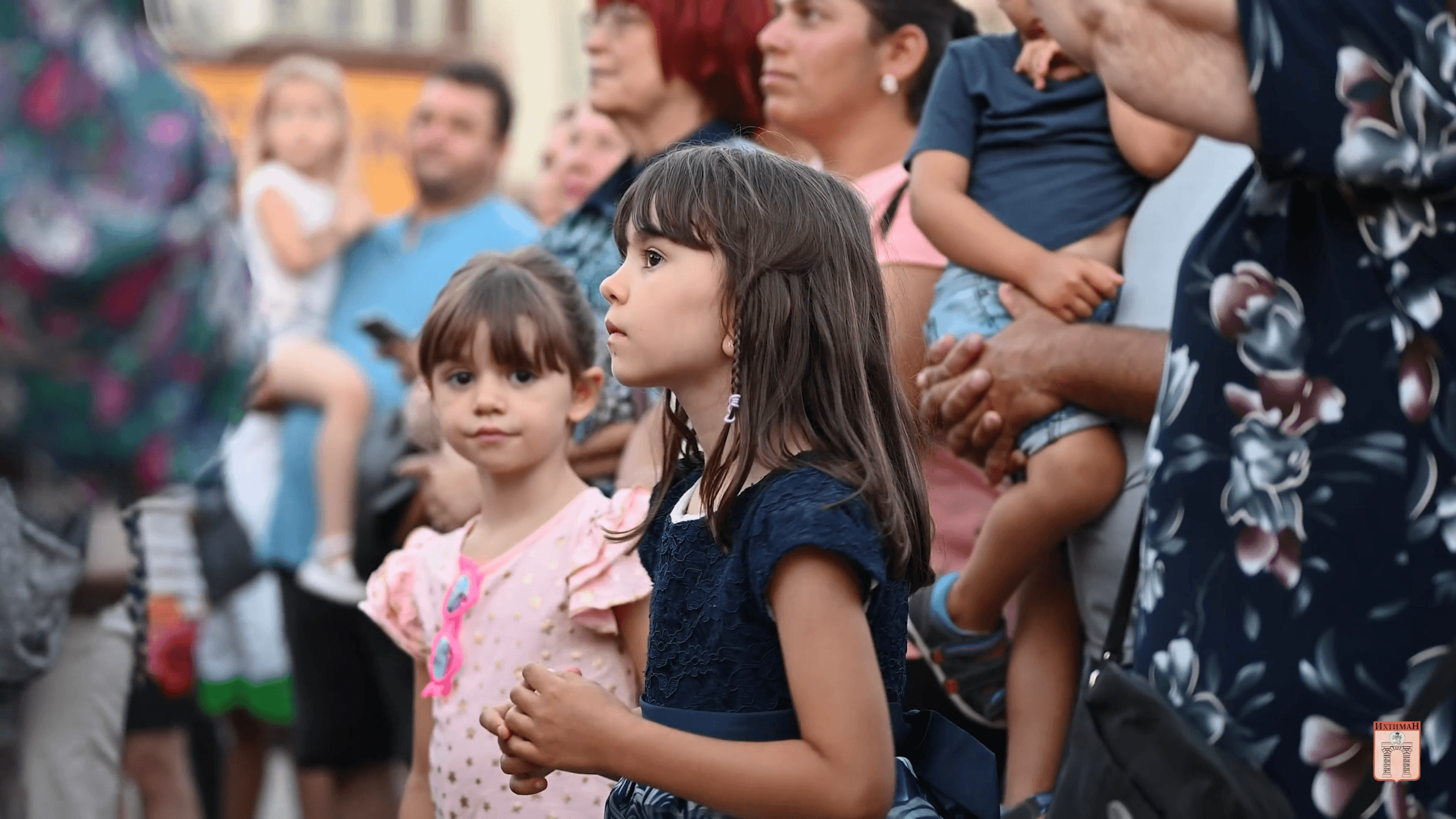 The children stare intently at the stage