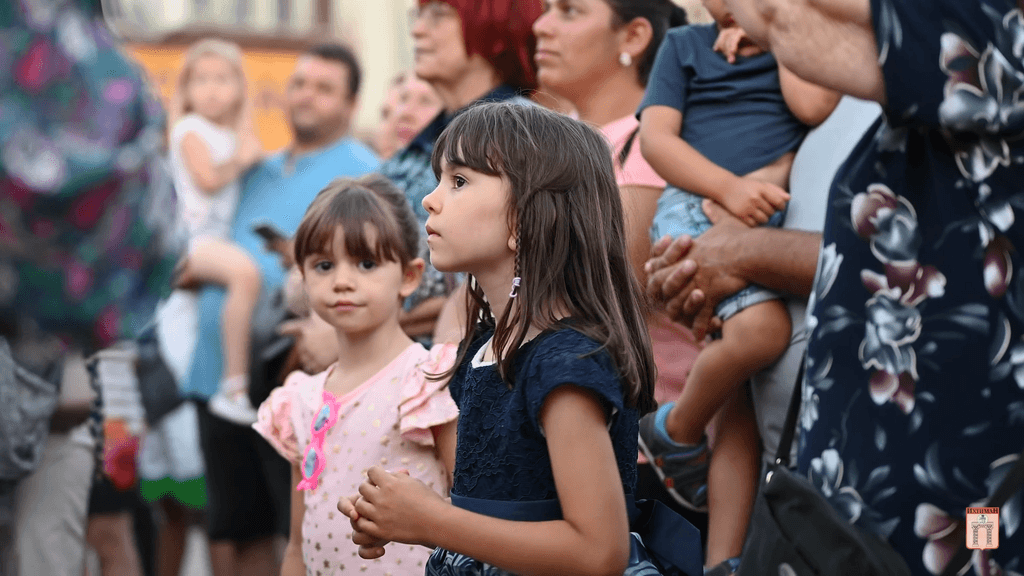 The children stare intently at the stage