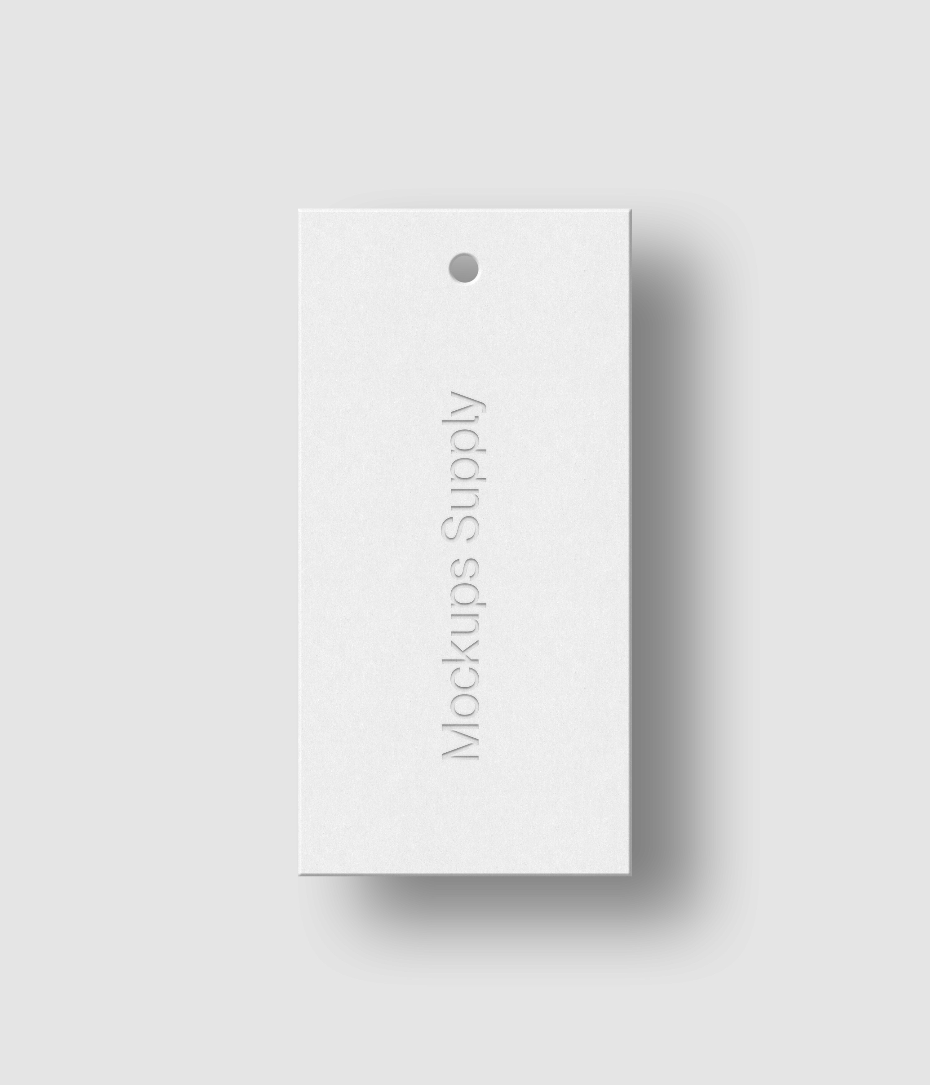 White 1x2 hang tag mockup on white background with realistic debossed logo effect and soft shadow for Photoshop download psd