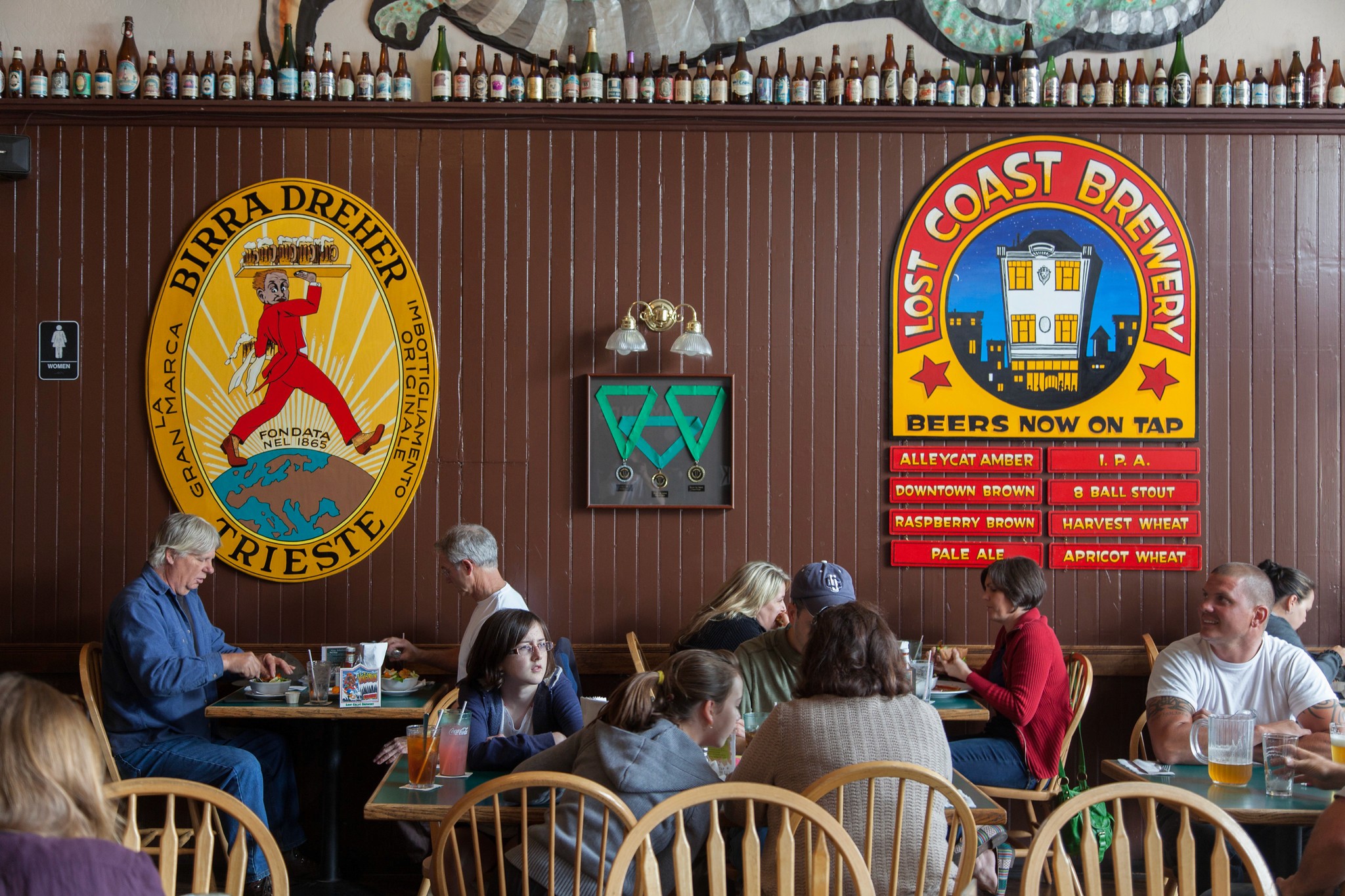 Diners and colorful brewery signs inside Lost Coast Brewery & Cafe in Eureka, photographed in 2012.