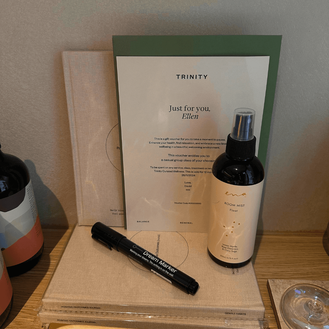 Woman speaking to a group during a yoga class in a serene studio.
