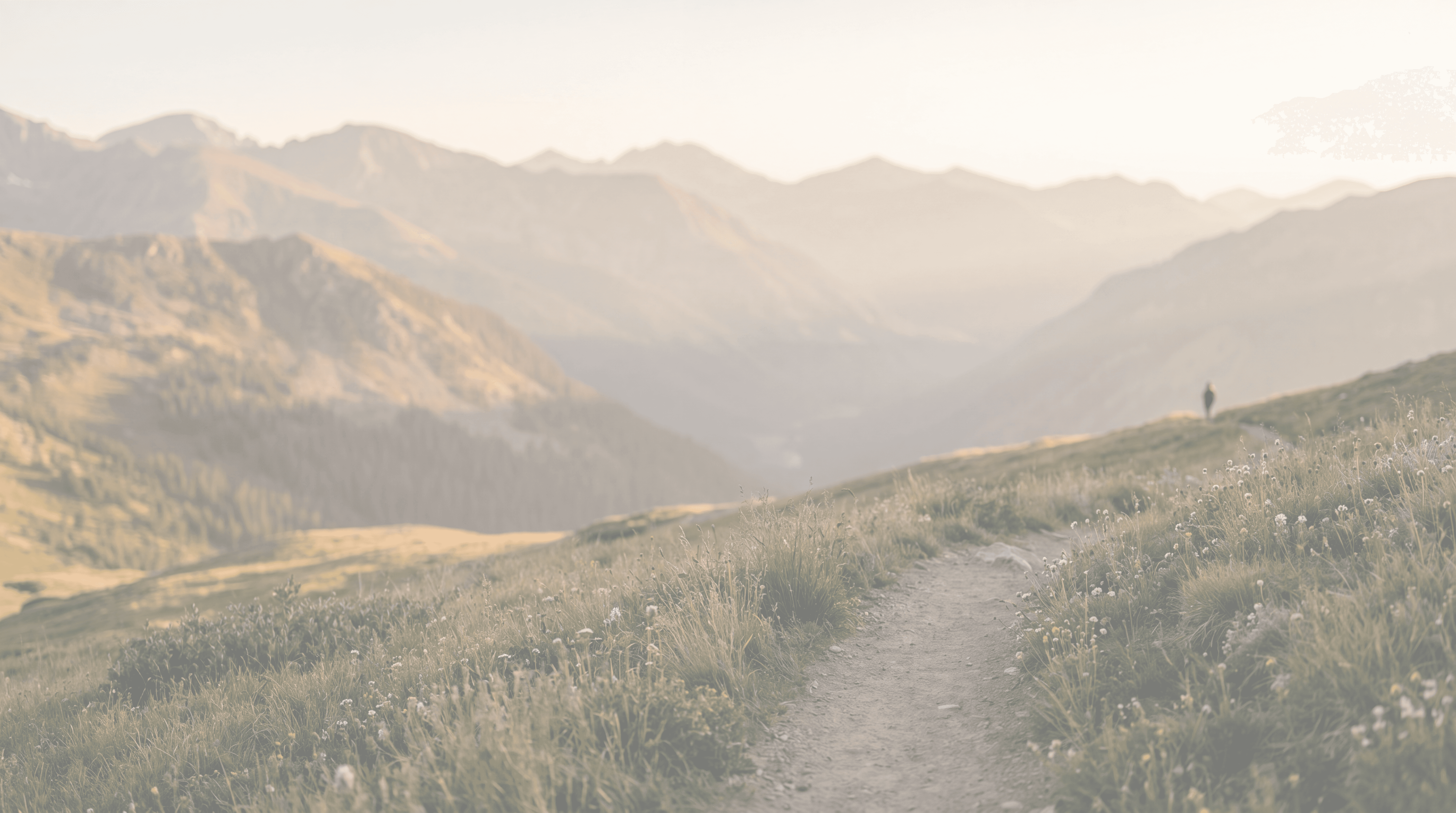 Mother and daughter outdoors, hiking near a large lake with mountains in the background.