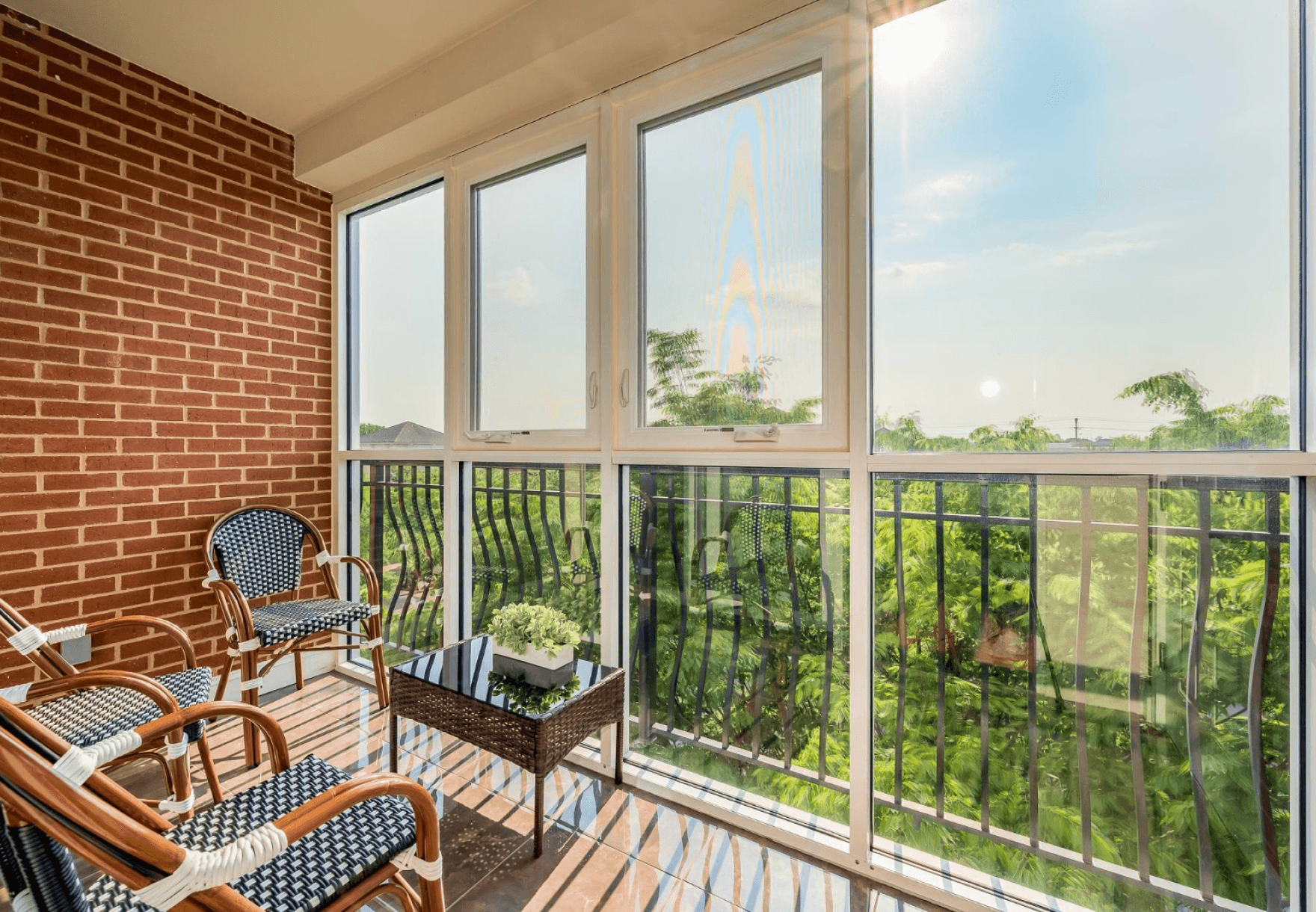 Bright, all-season sunroom at The Gateway Village, offering a tranquil and comfortable private space with scenic views.