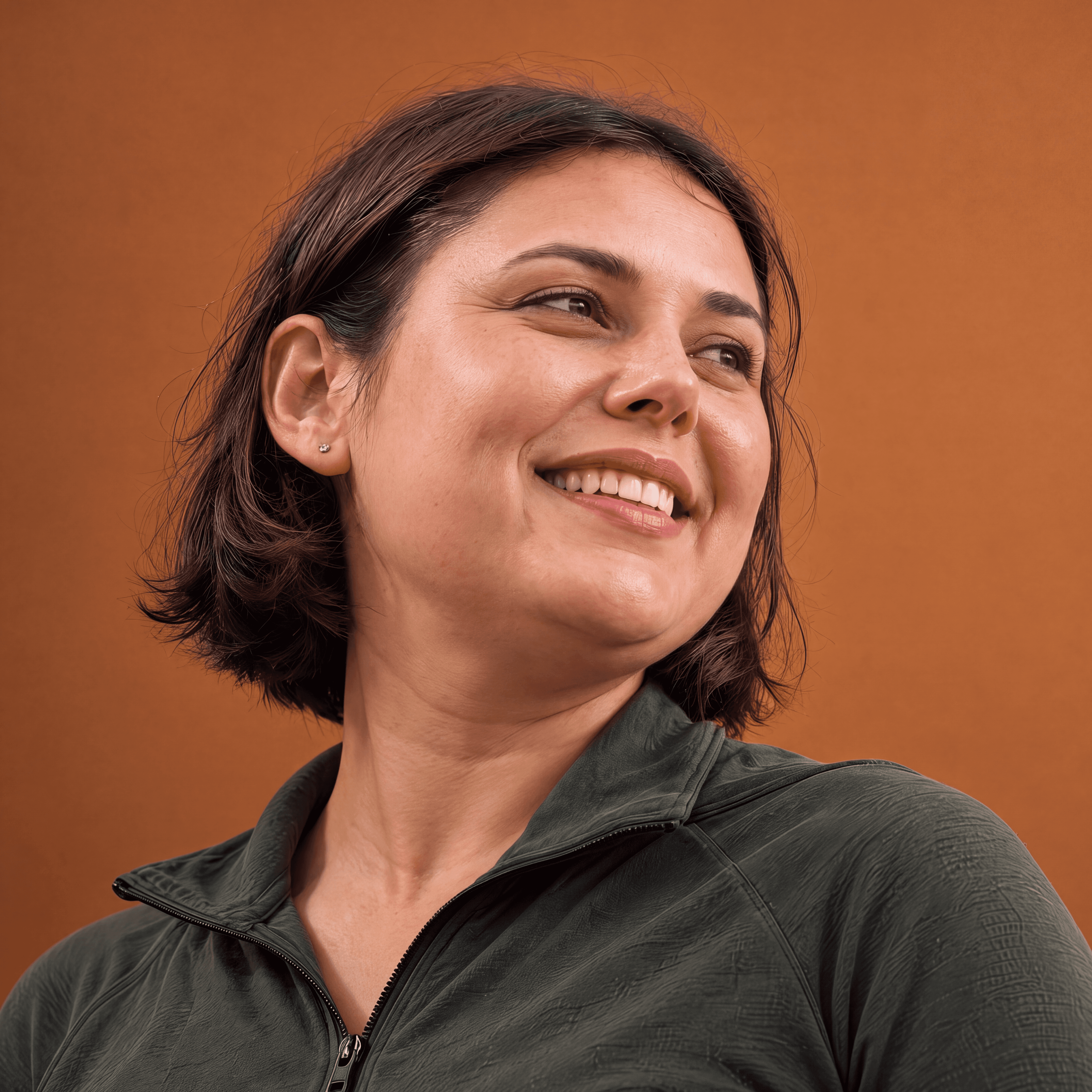 Smiling woman wearing a dark-green athletic top