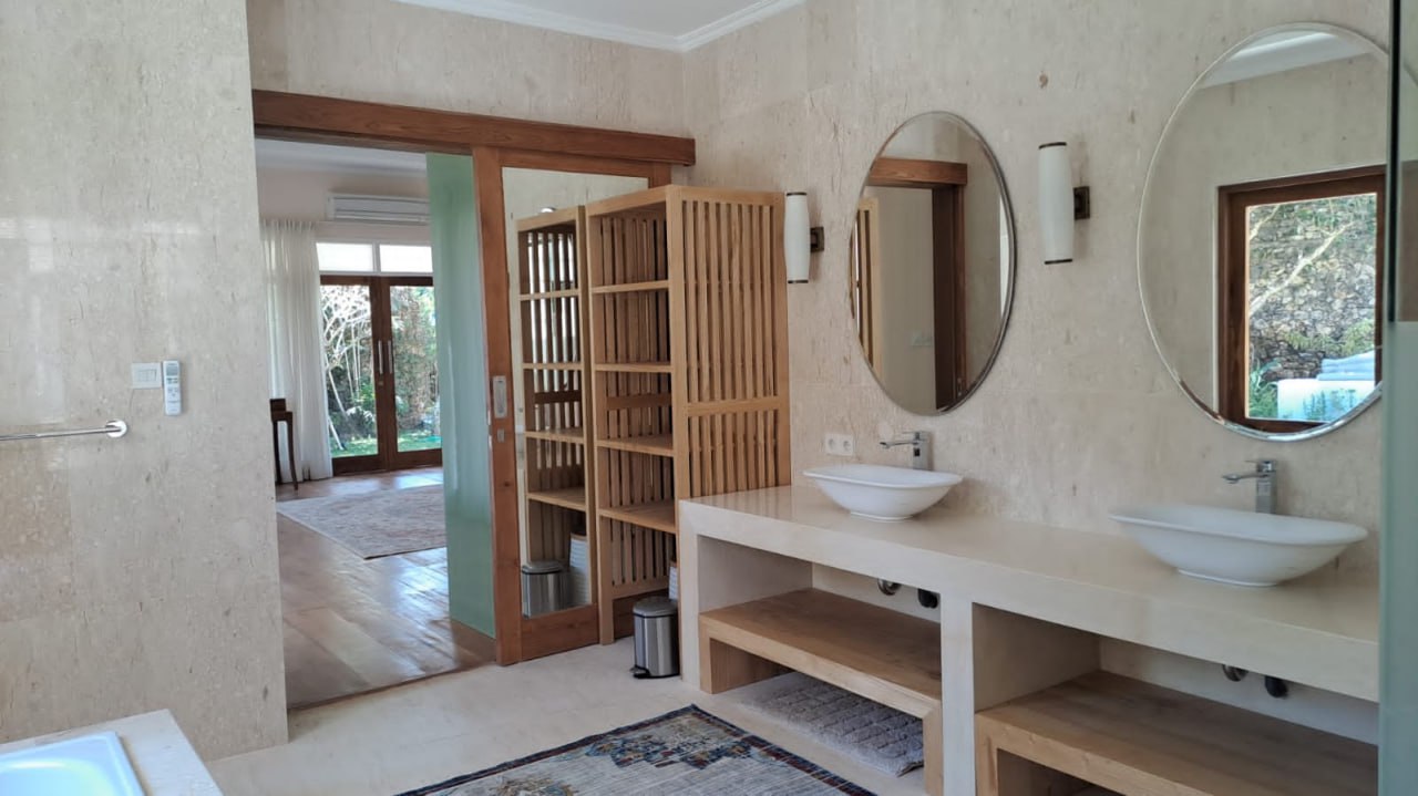 A 4-bedroom villa in a gated complex in Nusa Dua, featuring a large private garden and a peaceful residential environment