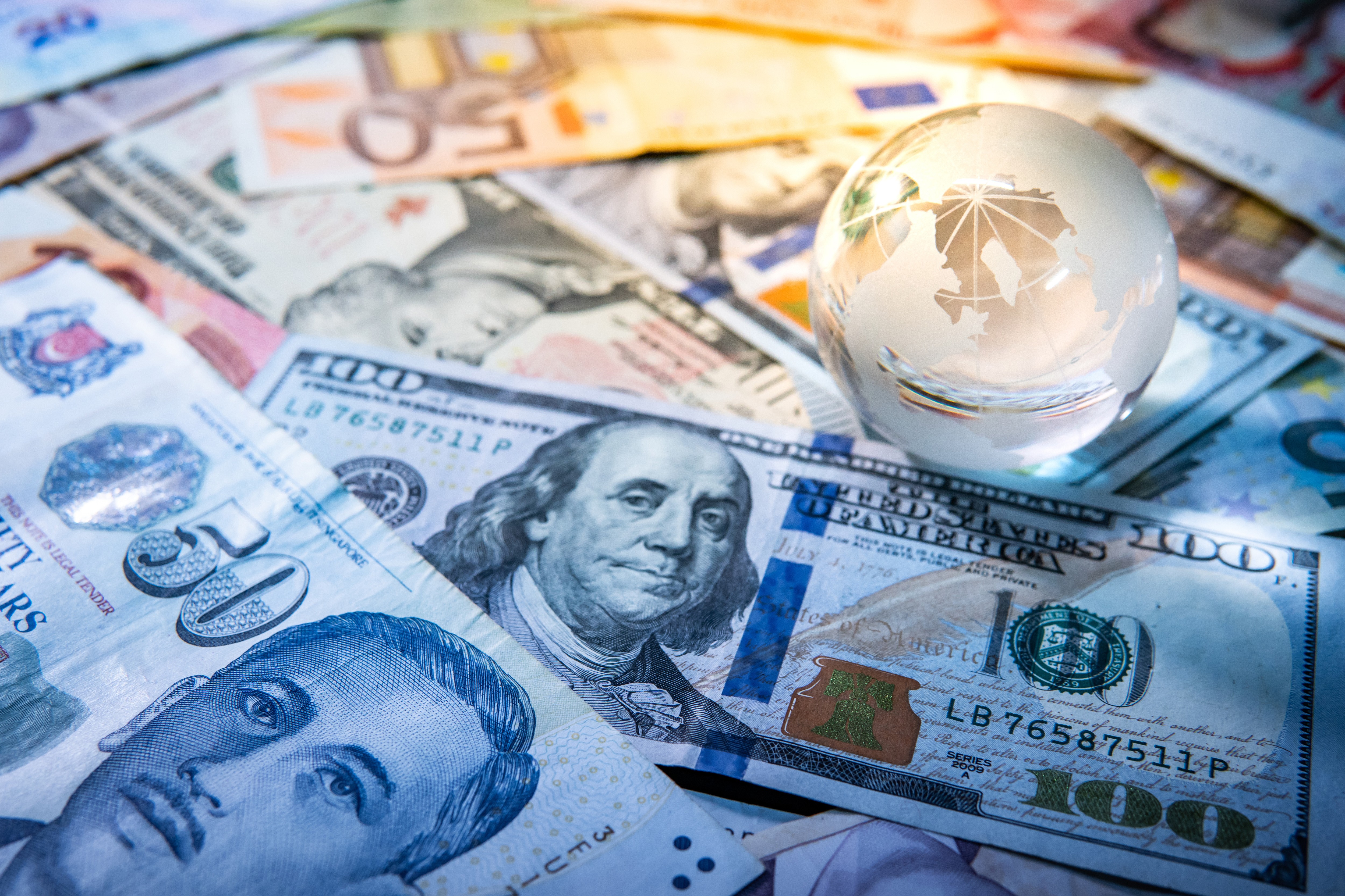 International banknotes with a glass globe
