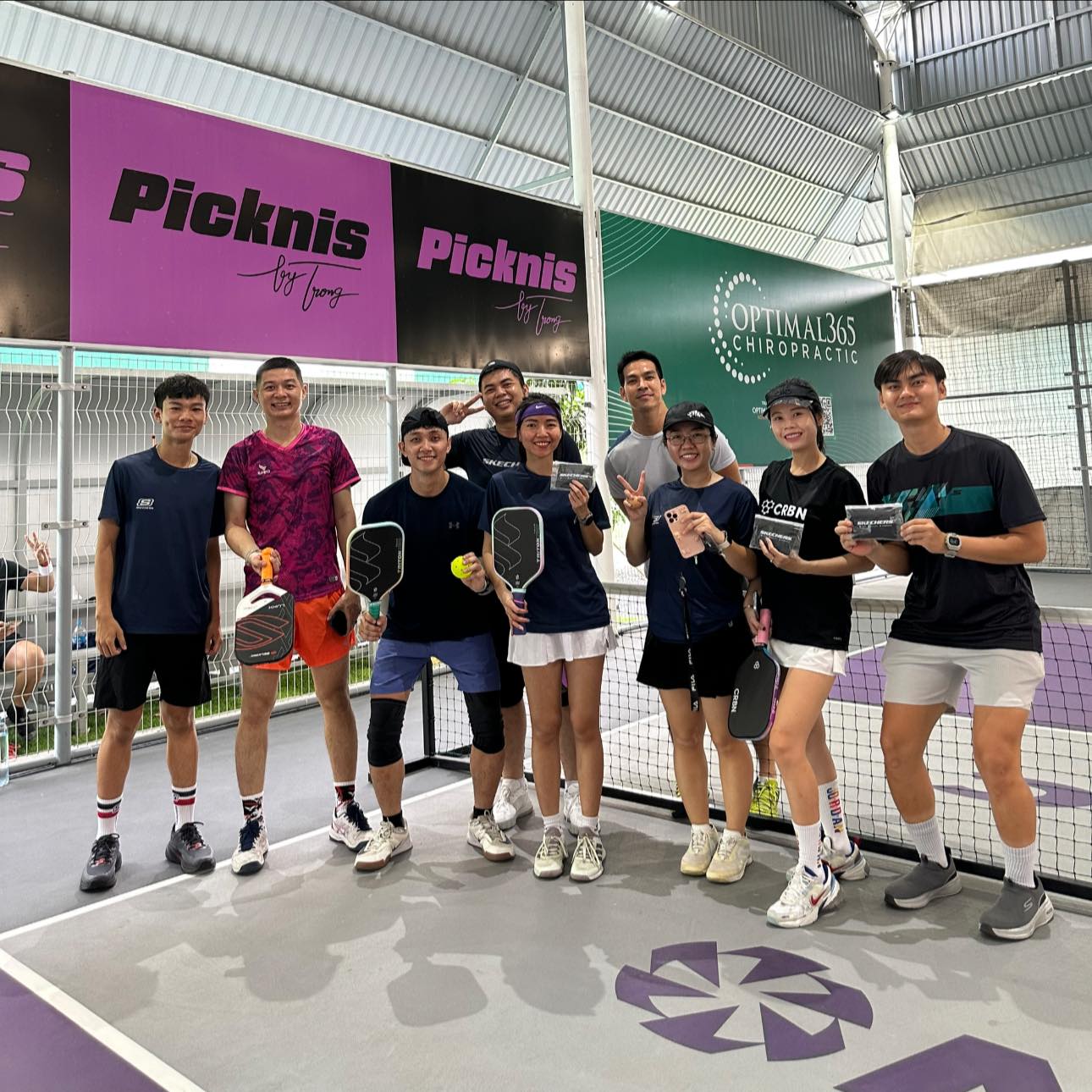 A man stading with Surfboard