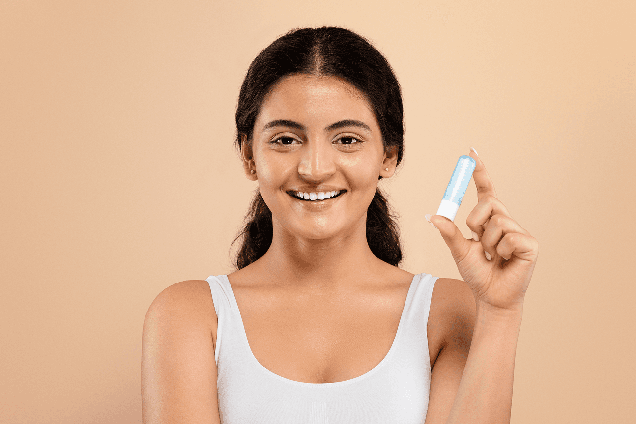 Image of a woman holding a beauty product and smiling, featured in a beauty and fashion video.
