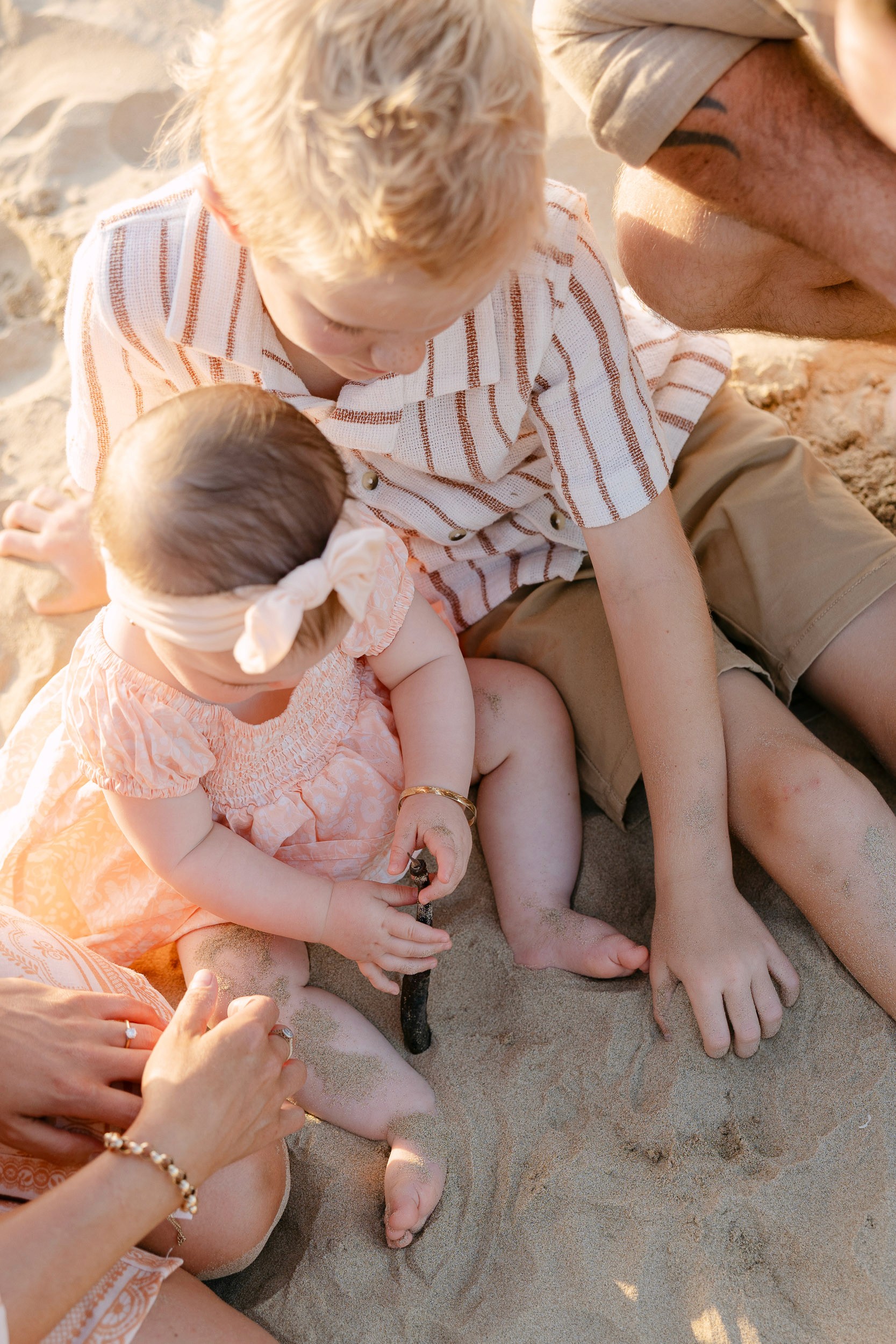 Top view of siblings on the sand at the beach in Mackay