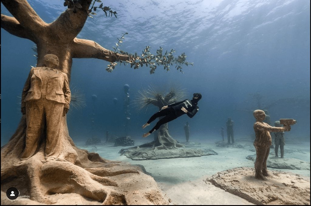 freediver meister swimming in underwater museum
