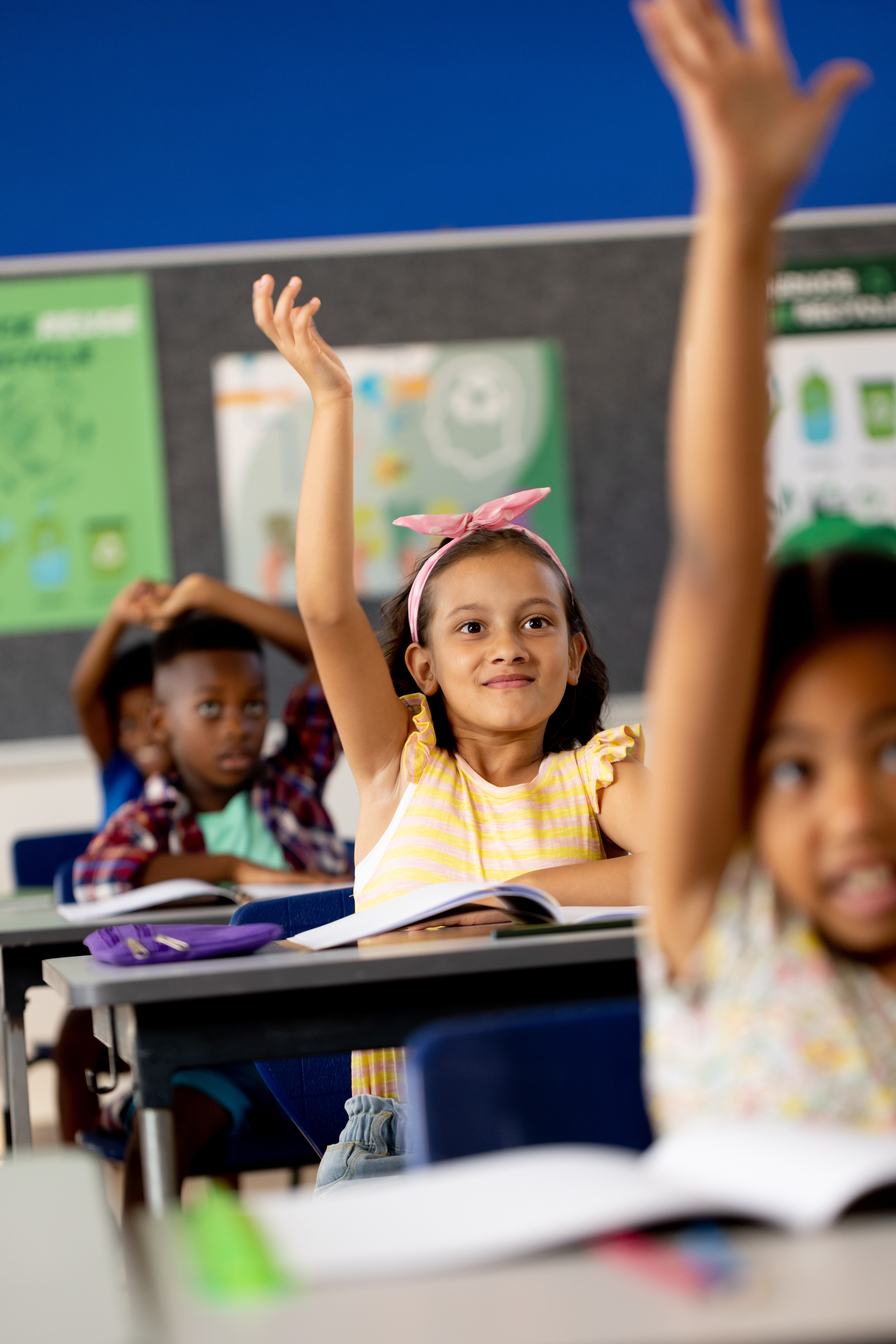 Kid raising hand in classroom
