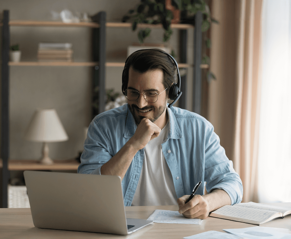 A photo that describes a Masterclass program on Horizon Search, showing a man sitting on a table and taking online class. 