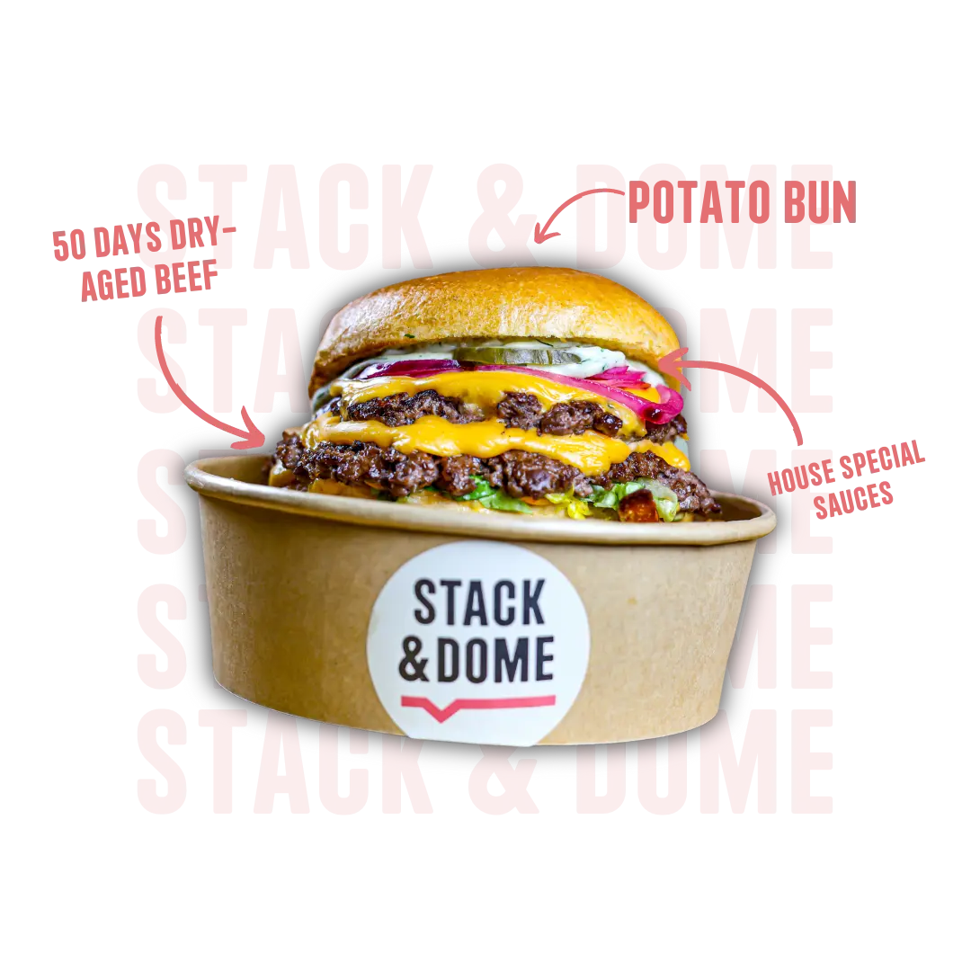 Our Blueprint Double smash burger sitting in a stack & dome bowl. with labled pointedat differnt parts of the burger