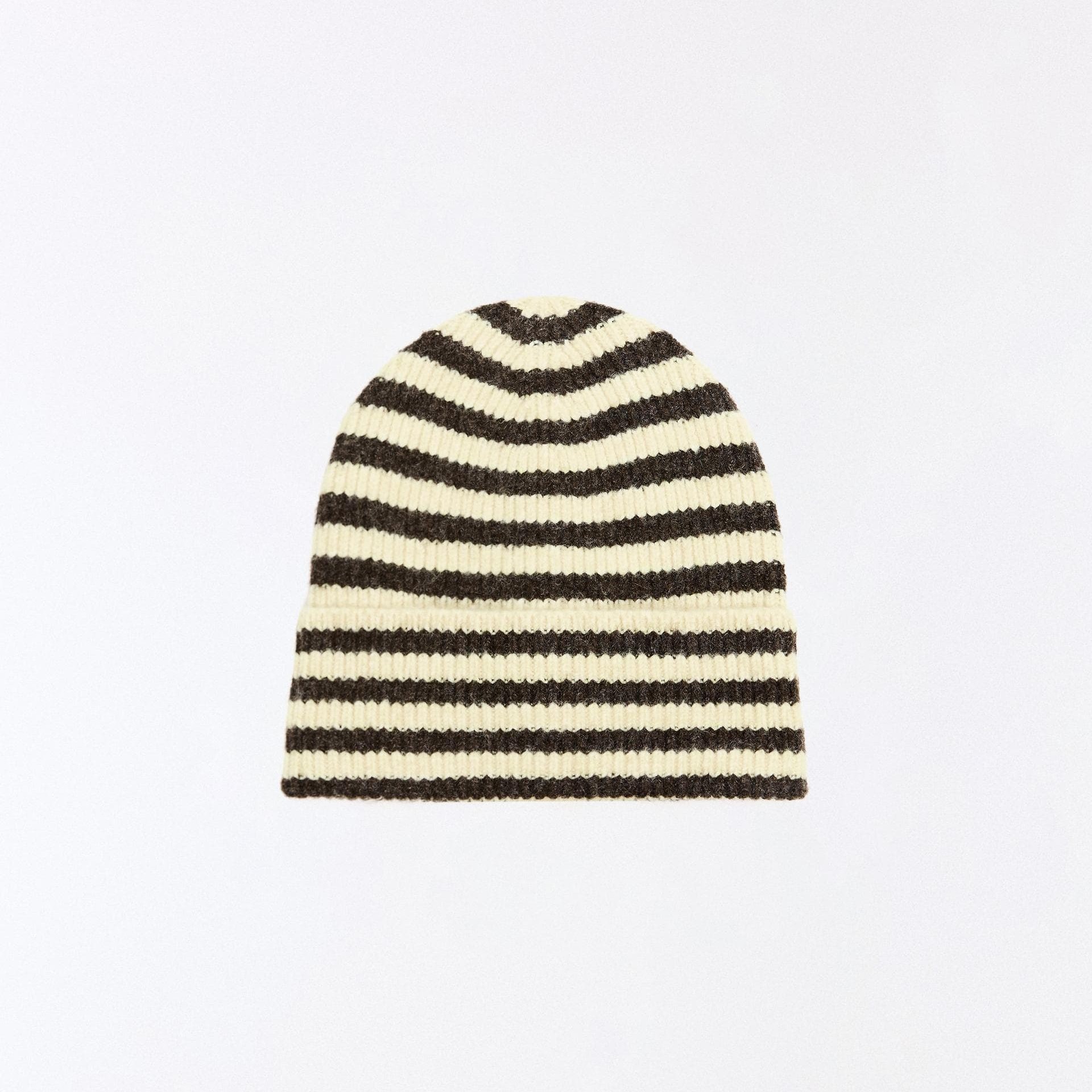 A person wearing a plain white t-shirt and a black baseball cap looks to the side, set against a neutral gray background.