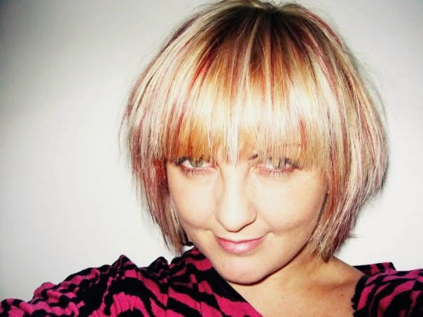 Young black woman witting at the table working on a laptop