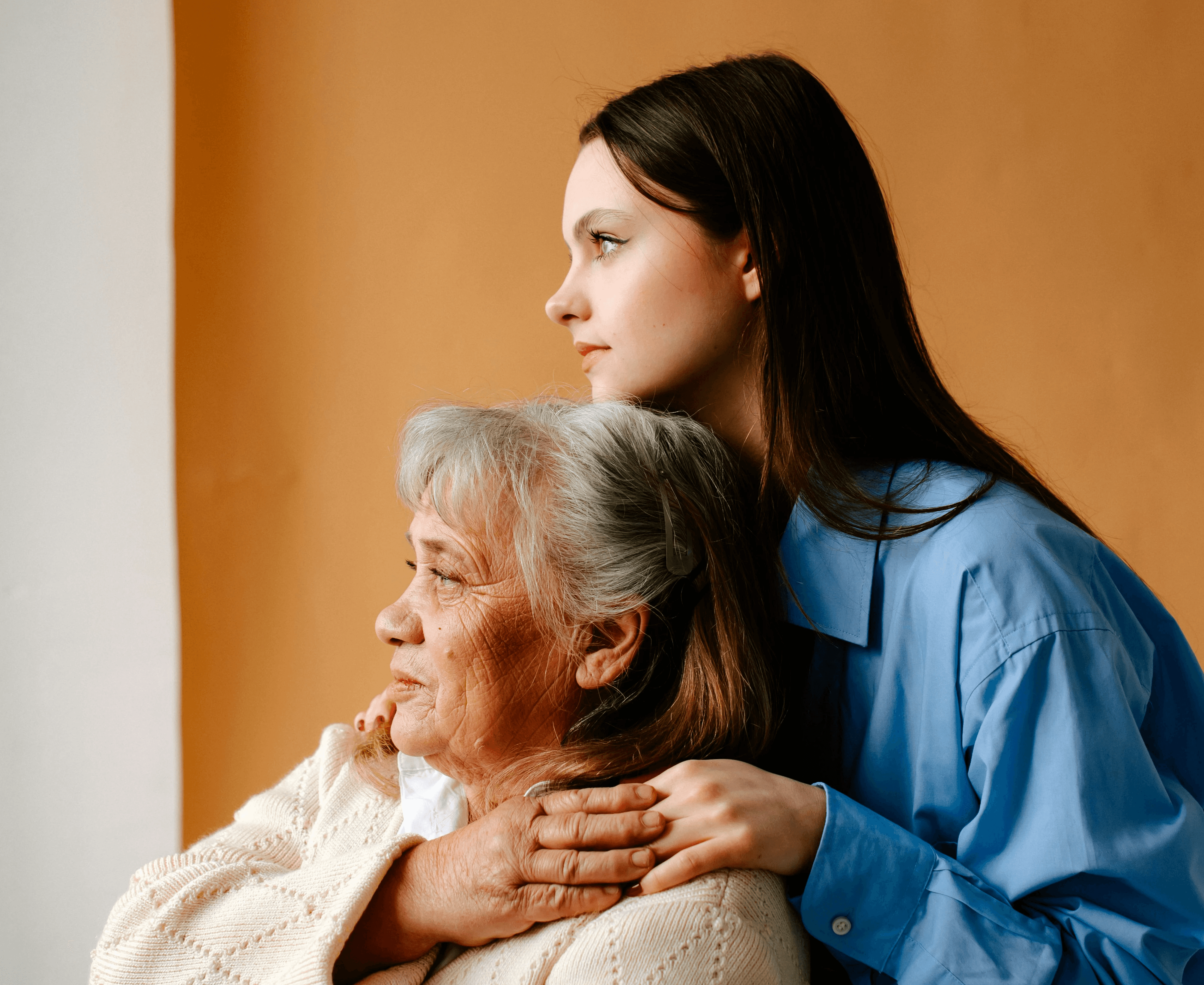 young woman holding elderly woman