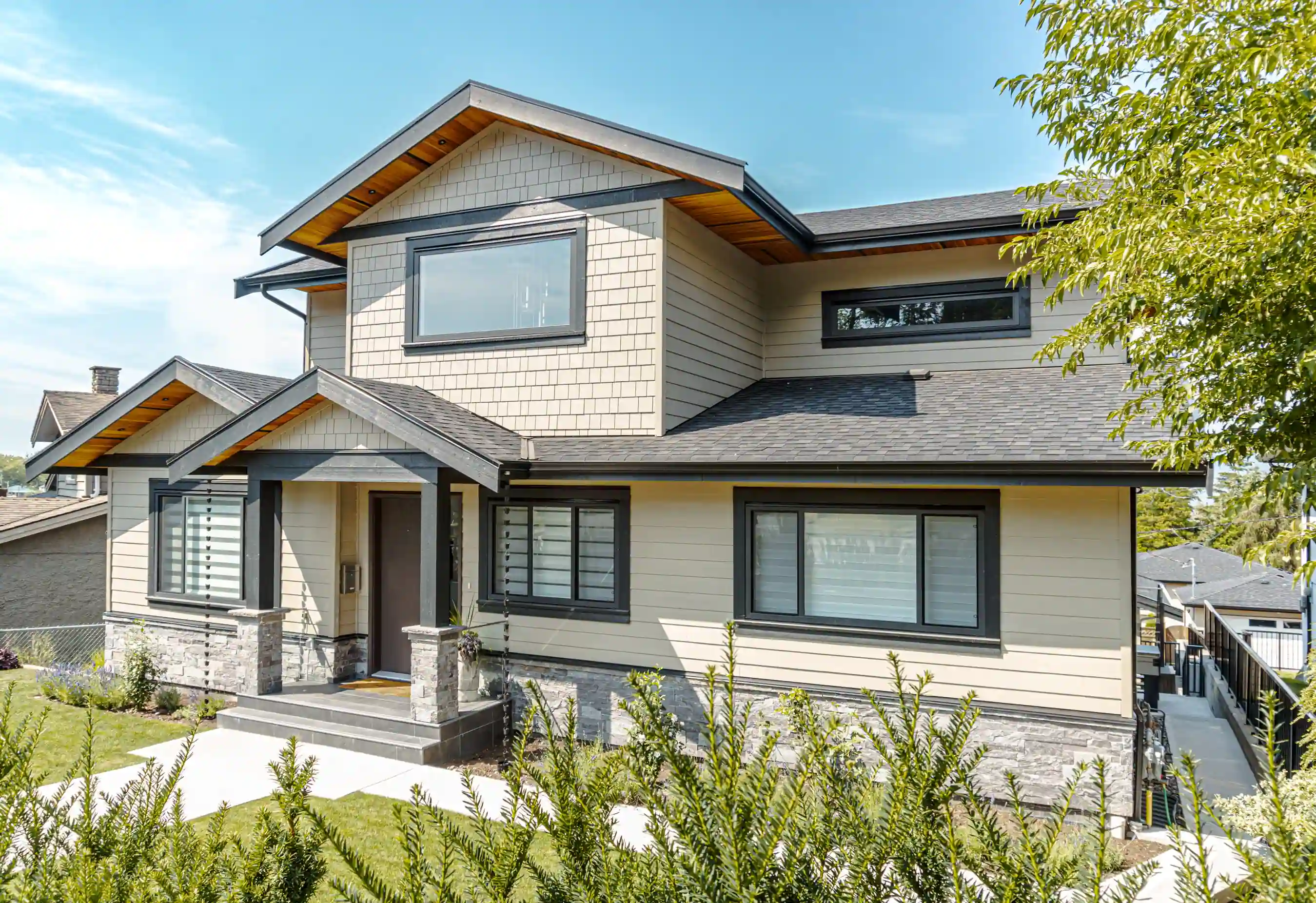 Exterior of the Elmwood custom home in Vancouver featuring modern residential design and stone details