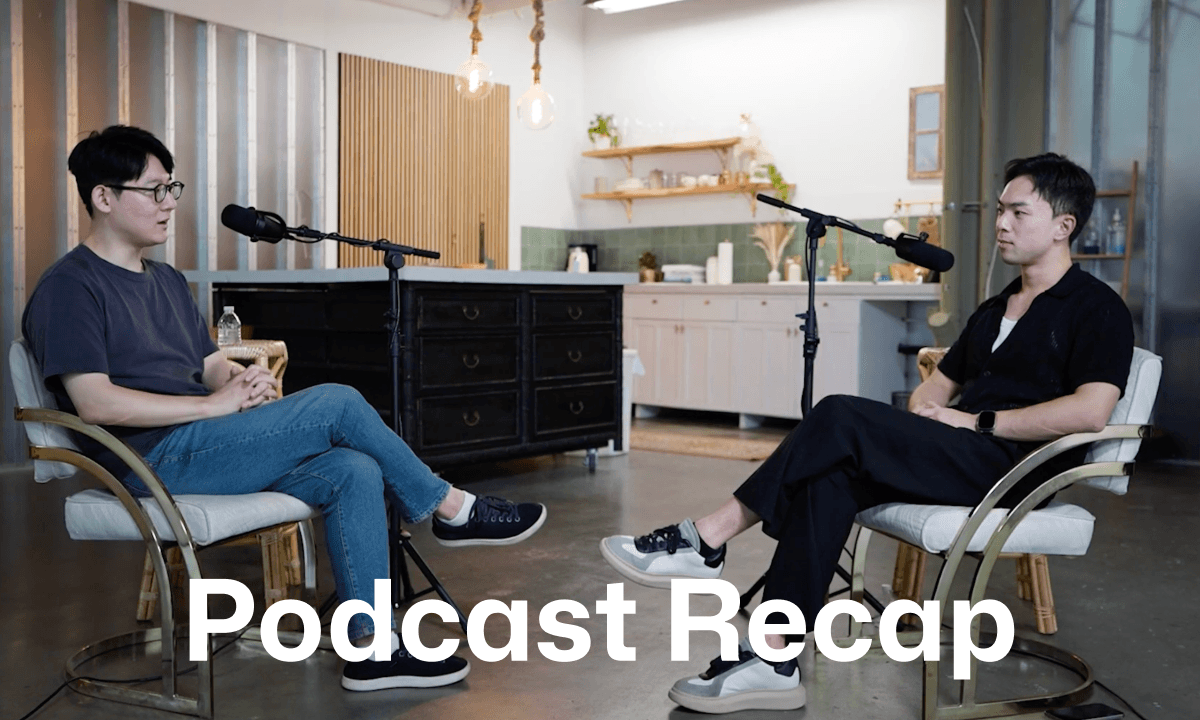 Two people recording a podcast-style conversation with microphones in a studio.