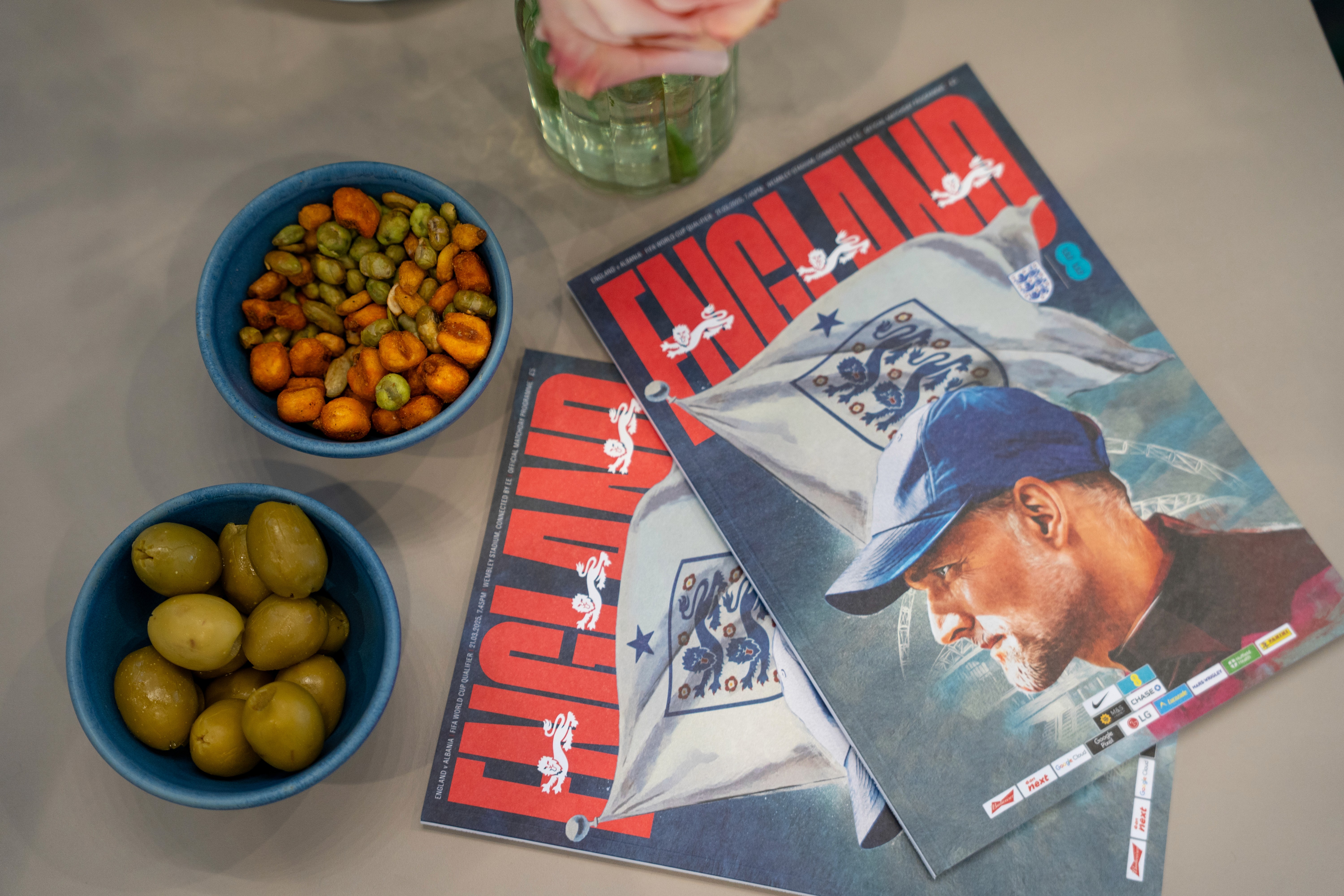 Close up of snacks and England football magazines displayed in the Wembley Stadium VIP area, captured by Seven Media to showcase the elevated match day experience.