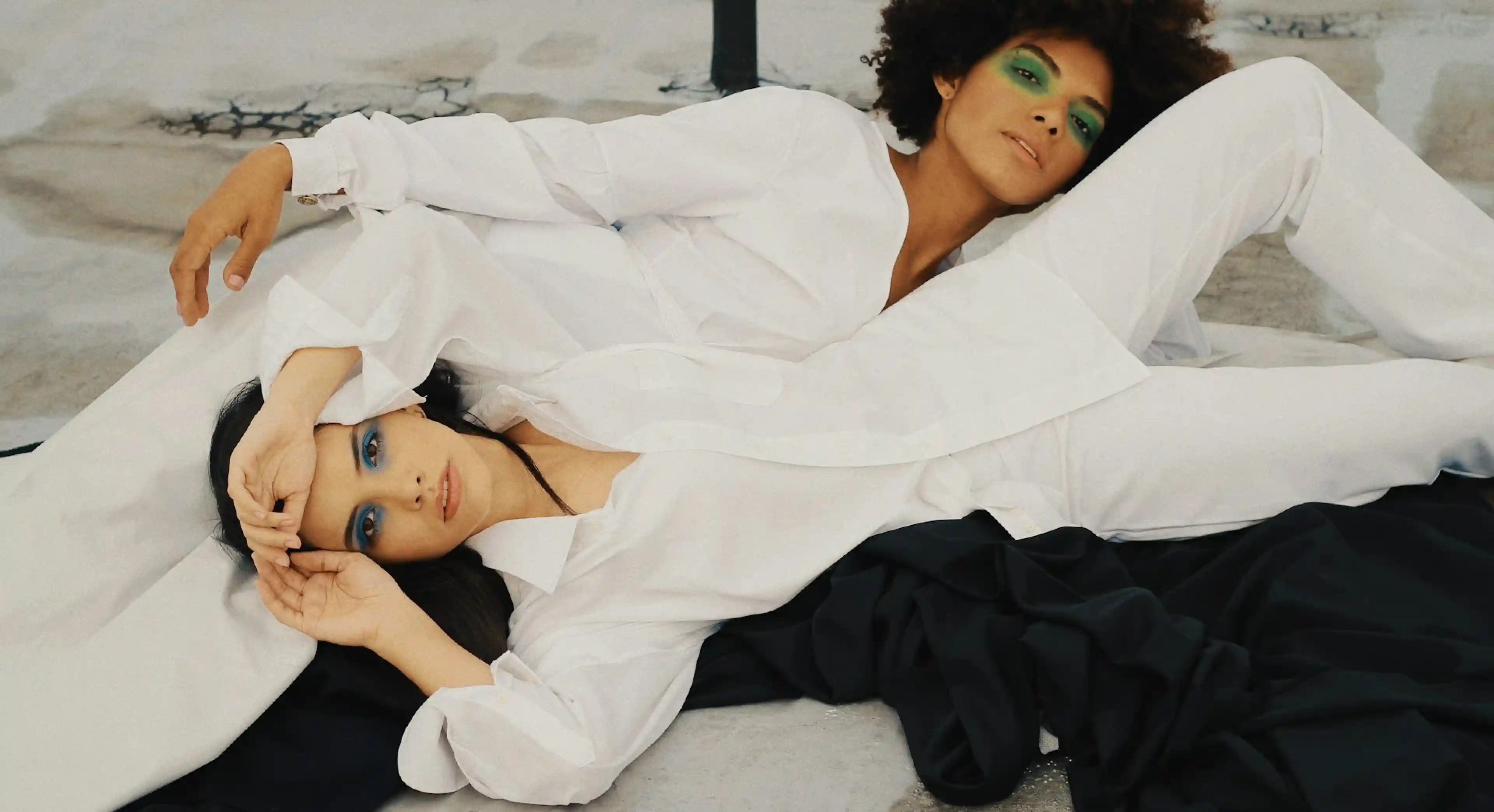 Two female models dressed in white.