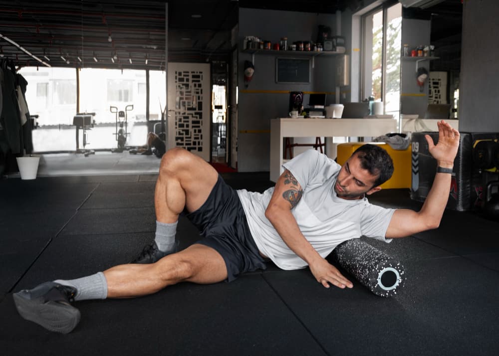 A man and a woman working out in a gym