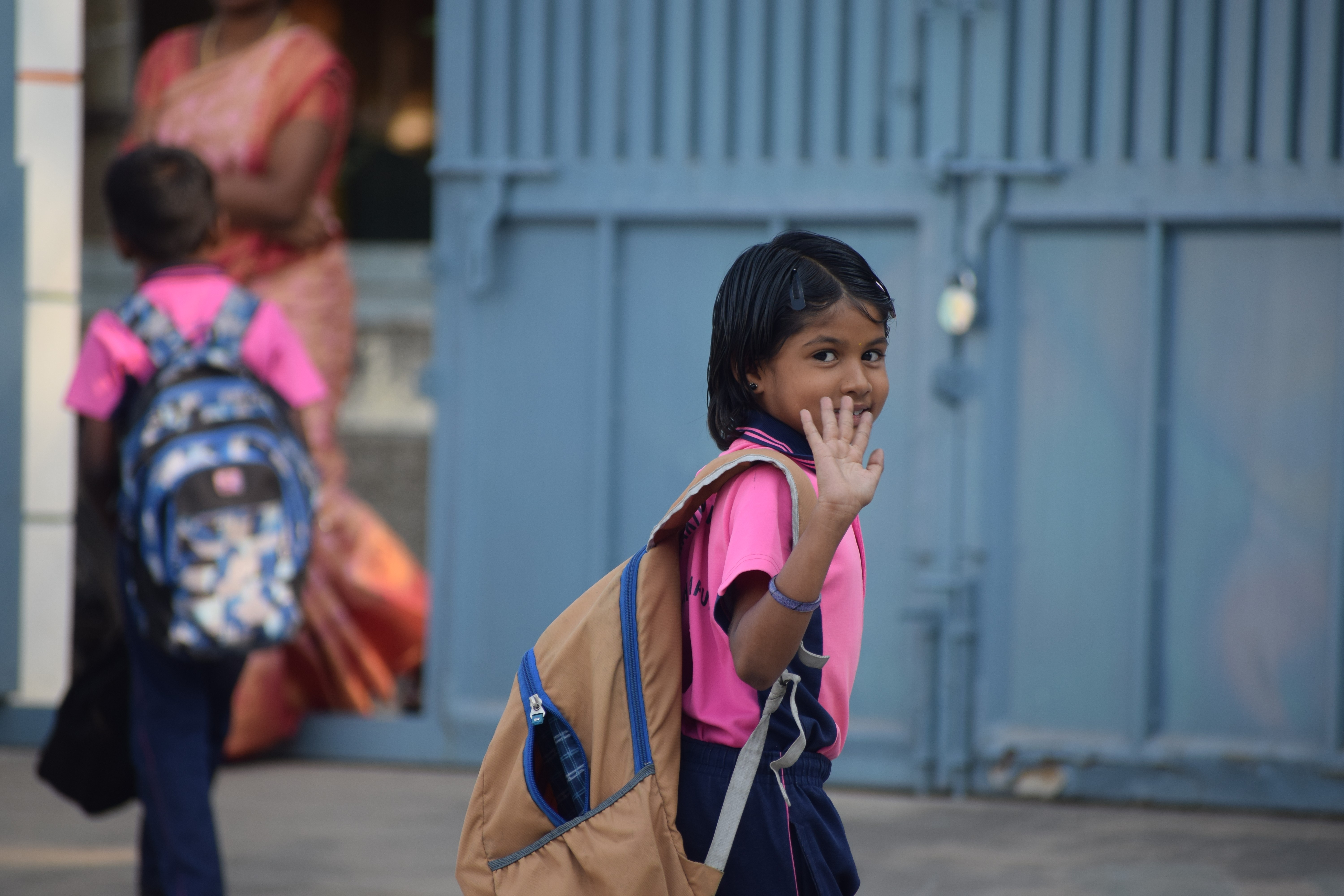 A student stands with a backpack on, ready for school