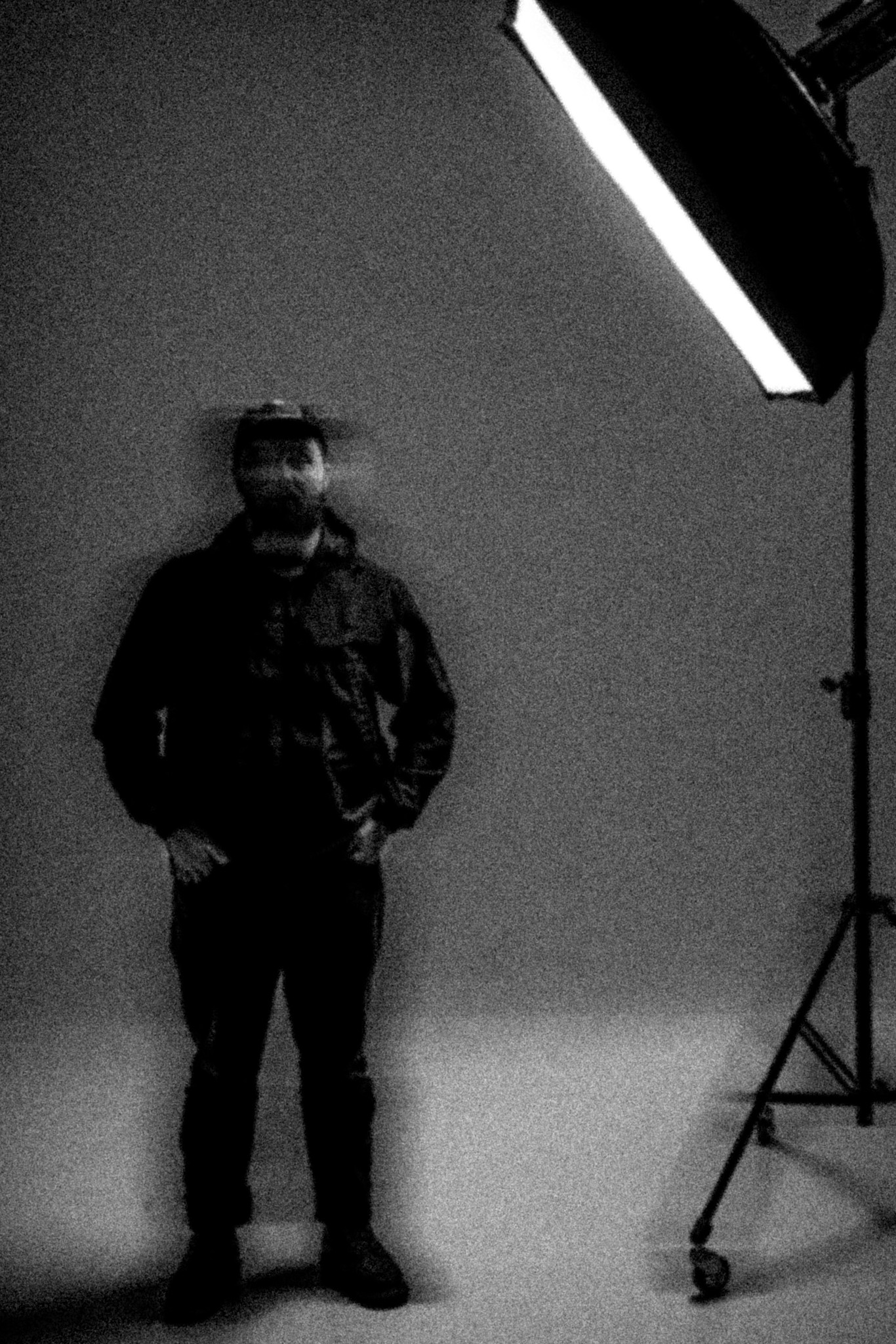 a blurry photo of a person standing in front of a wall