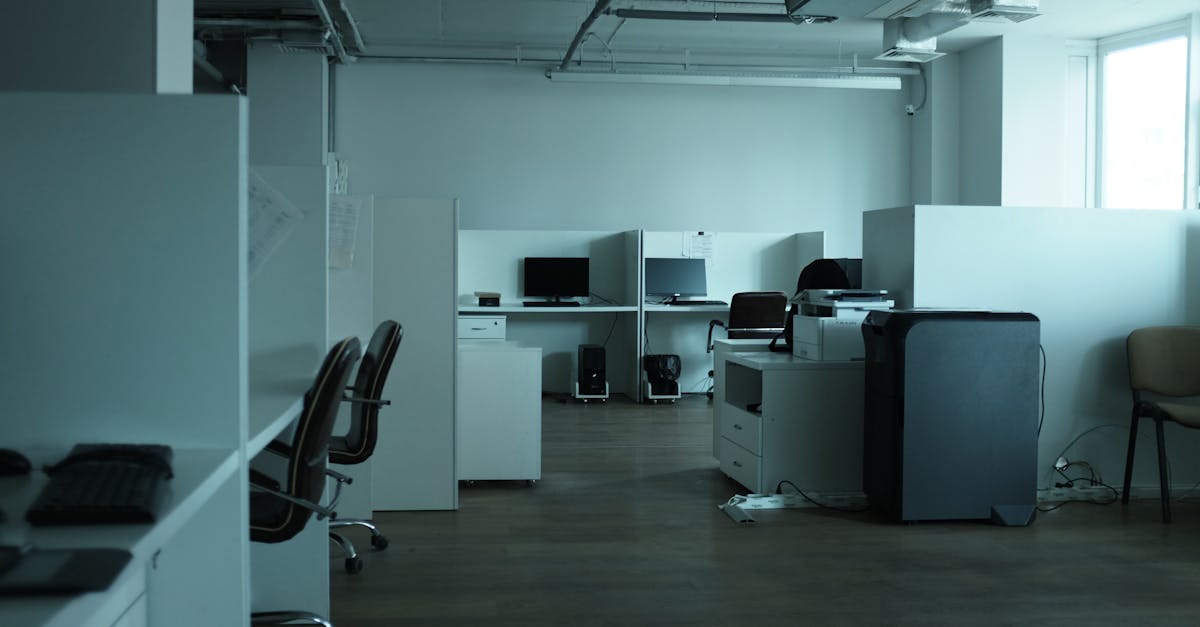 An empty modern office space in Kyiv featuring workstations, chairs, and technology.