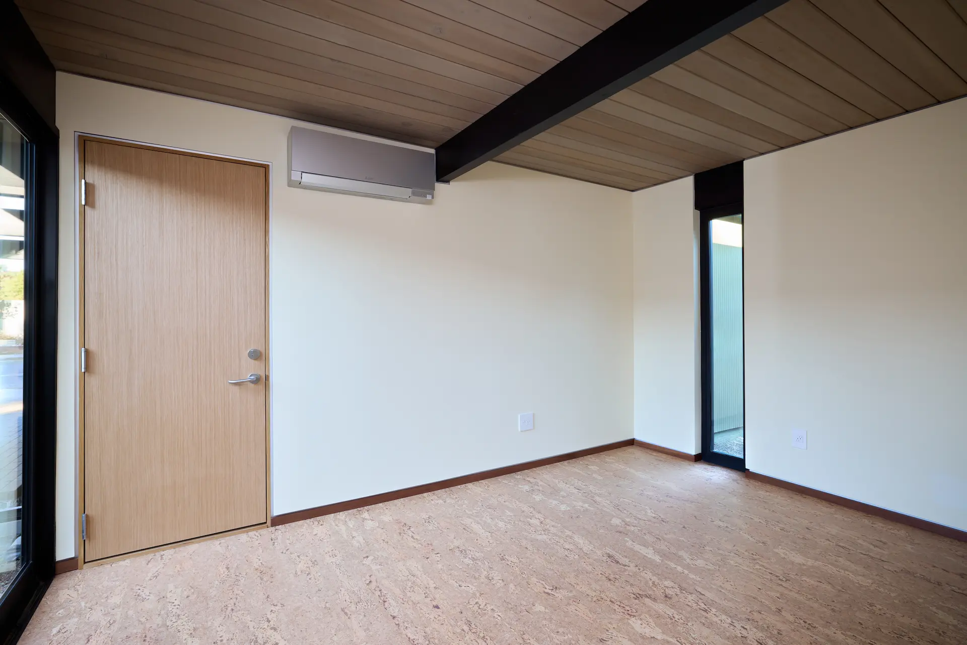 View of the guest bedroom, featuring contemporary design elements that complement the home's historical character. Photo by Todd Huge.