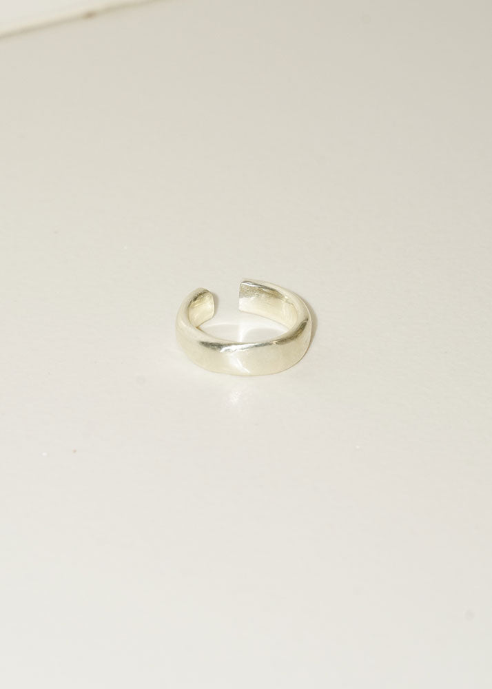 Silver ring on a light beige background