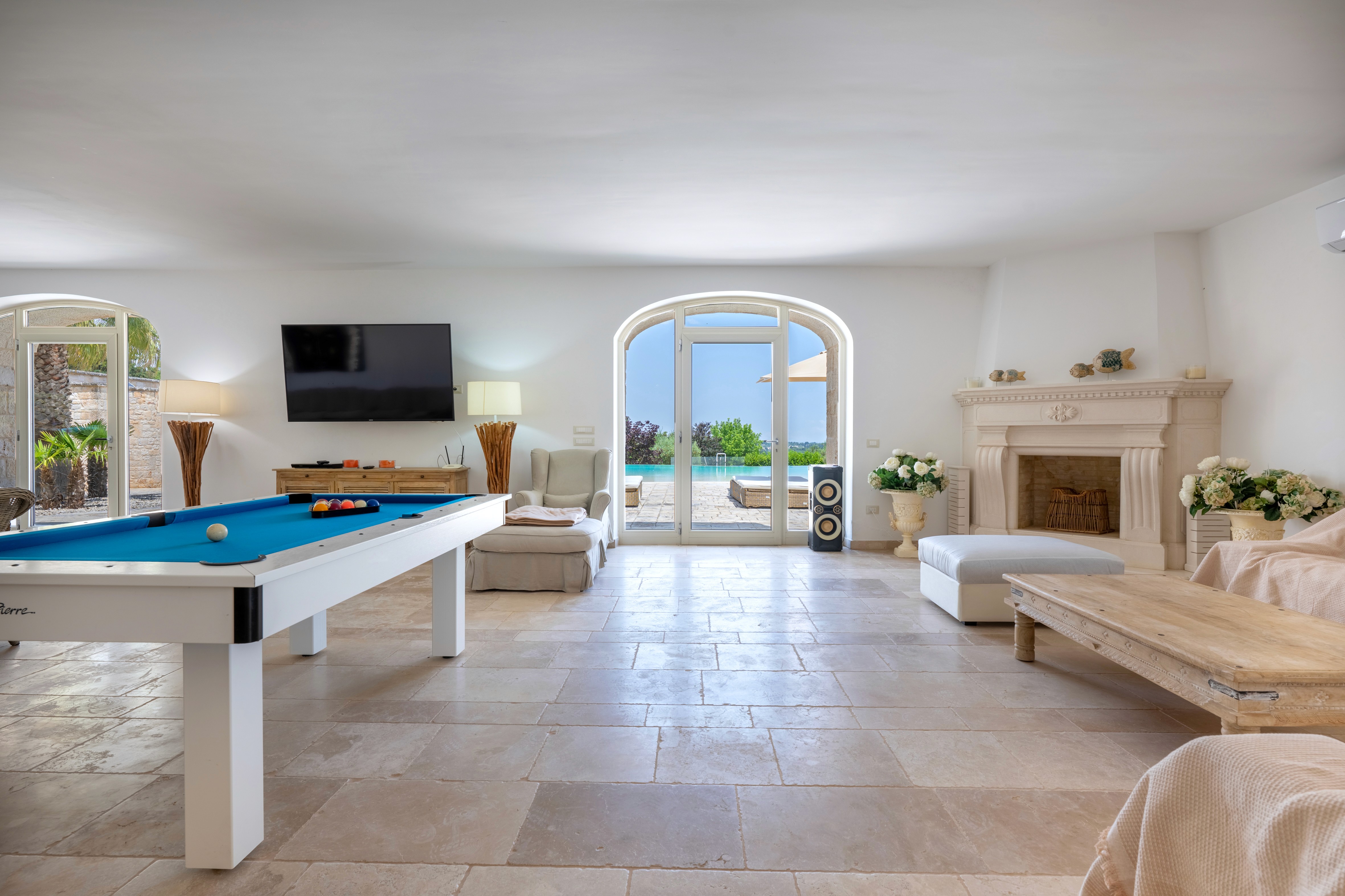 Modern living room with black leather sofas and tree-patterned rug