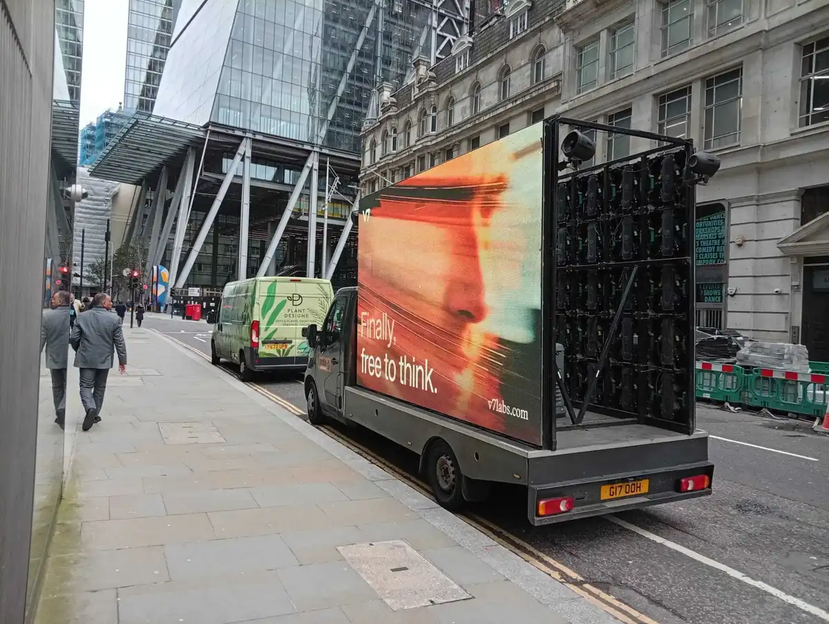 A V7 digital advertising truck parked on a street in the City of London showing the ‘Finally, free to think’ campaign