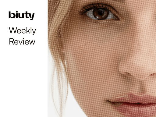 Soft pink tulips bloom in a field.