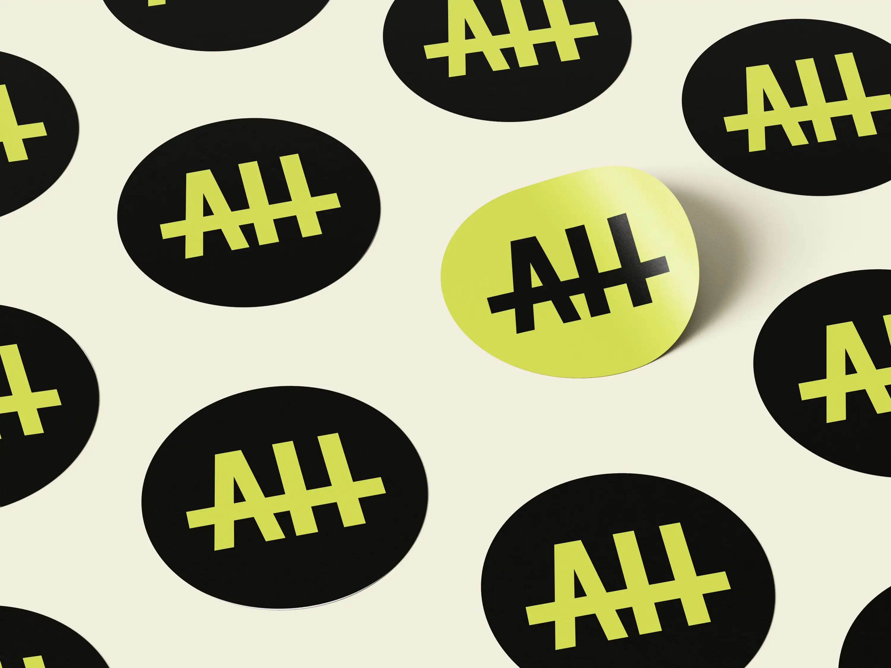 A round green sticker featuring a black silhouette of a creature with a long tail and playful design.