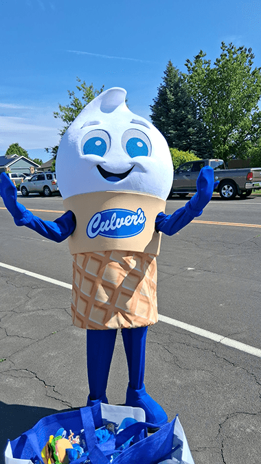 Cooper stands in the road in a Scoopie Culver's mascot costume.